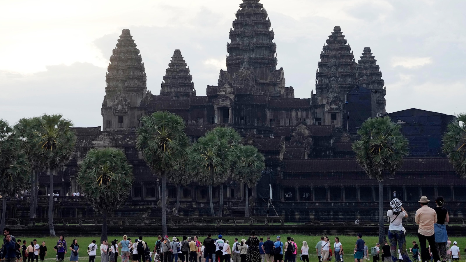 A night bus from Cambodia's top tourist destination plunges off a bridge, killing 13 passengers