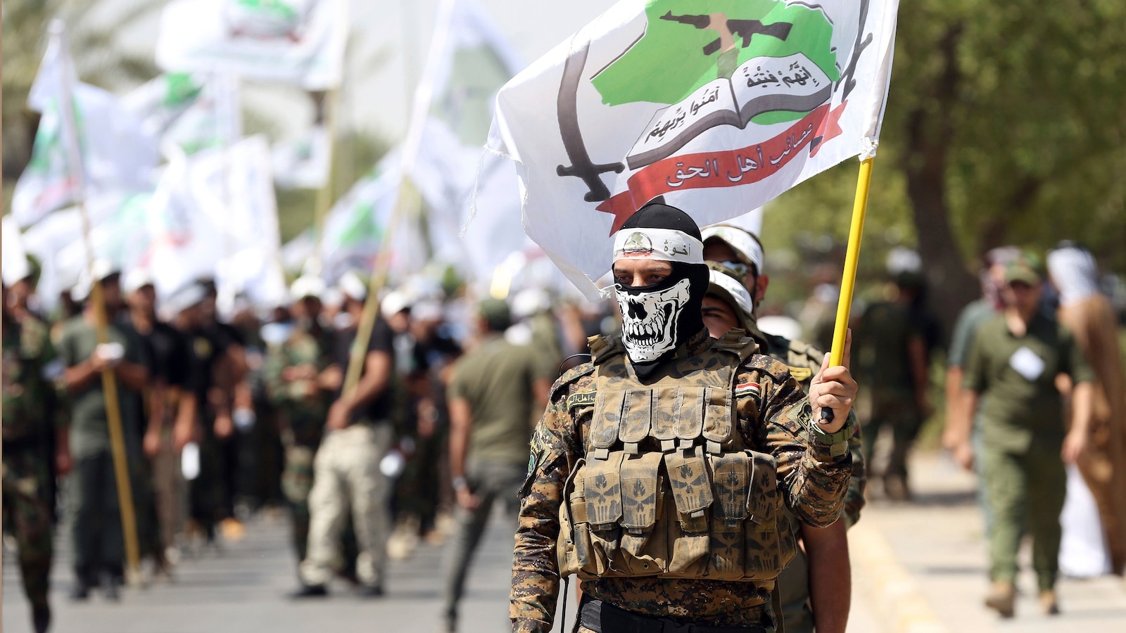 Powerful Iran-backed Iraqi militia says it will start handing its weapons to the state