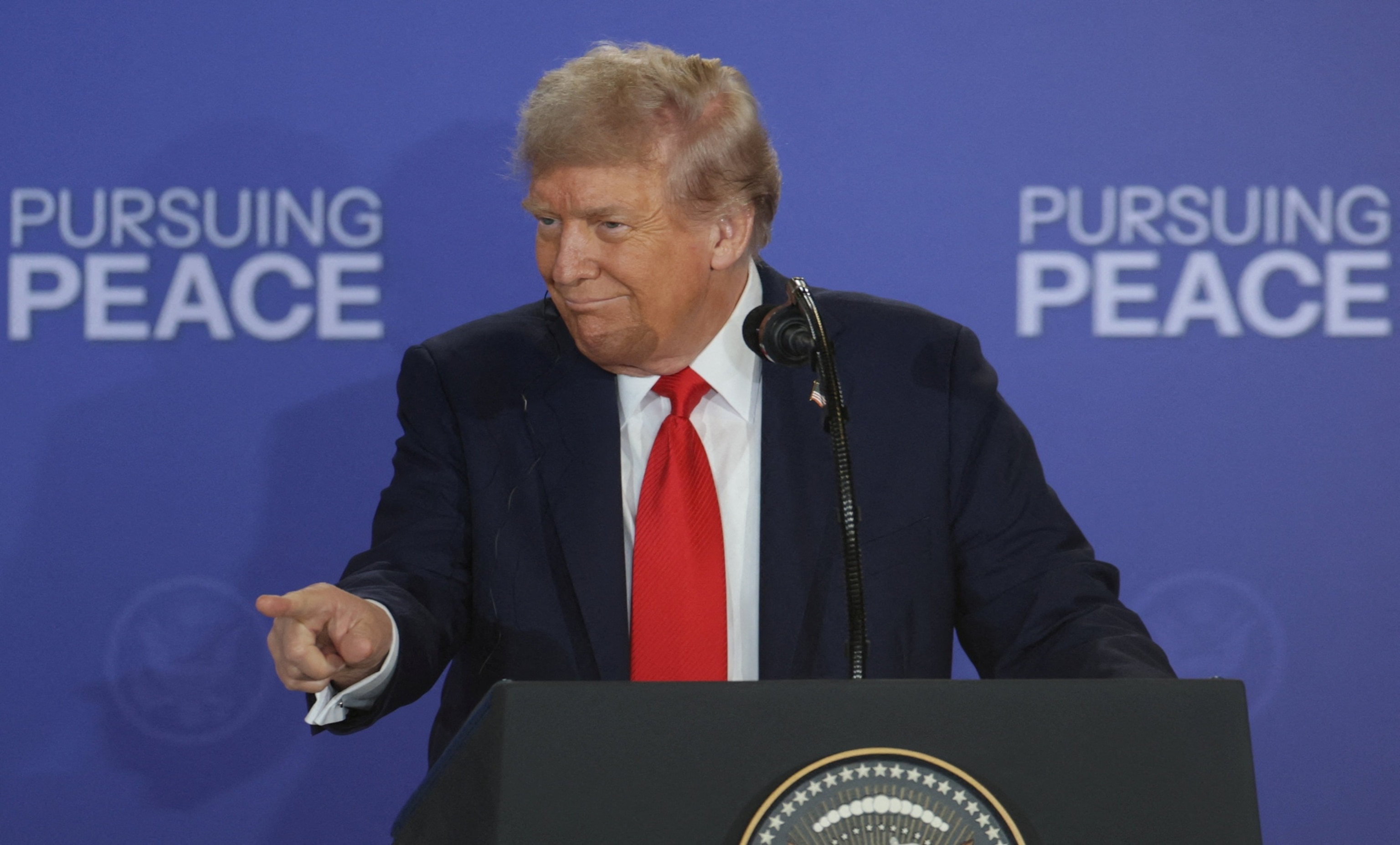 PHOTO: President Donald Trump gestures as he holds a press conference with Russian President Vladimir Putin following their meeting  to negotiate an end to the war in Ukraine, at Joint Base Elmendorf-Richardson in Anchorage, Alaska, August 15, 2025. 