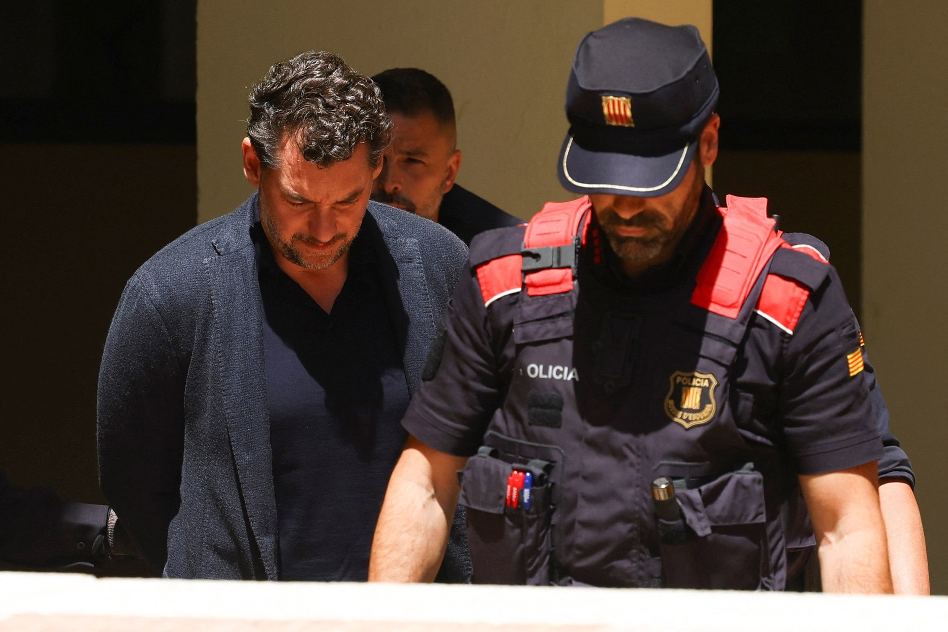 PHOTO: Jonathan Andic arrives at court escorted by police, after being detained in an investigation of the death of his father, who was killed in a fall from a cliff near Barcelona in December 2024, in Martorell, Spain, May 19, 2026. 