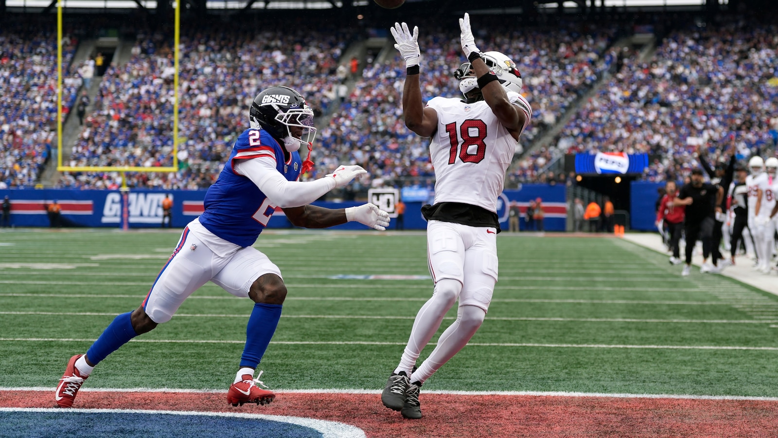 Marvin Harrison Jr. of the Arizona Cardinals catches a touchdown pass over New York Giants cornerback Deonte Banks in East Rutherford, N.J., on Oct. 4, 2026, his only catch of his final game for Arizona.
