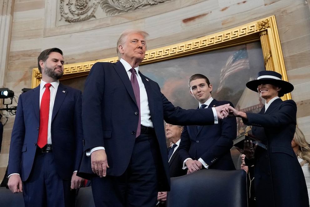 PHOTO: President Donald Trump, center, holds the hand of his wife Melania Trump, right, as their son Barron Trump, center after taking the oath of office during the 60th Presidential Inauguration on Jan. 20, 2025.