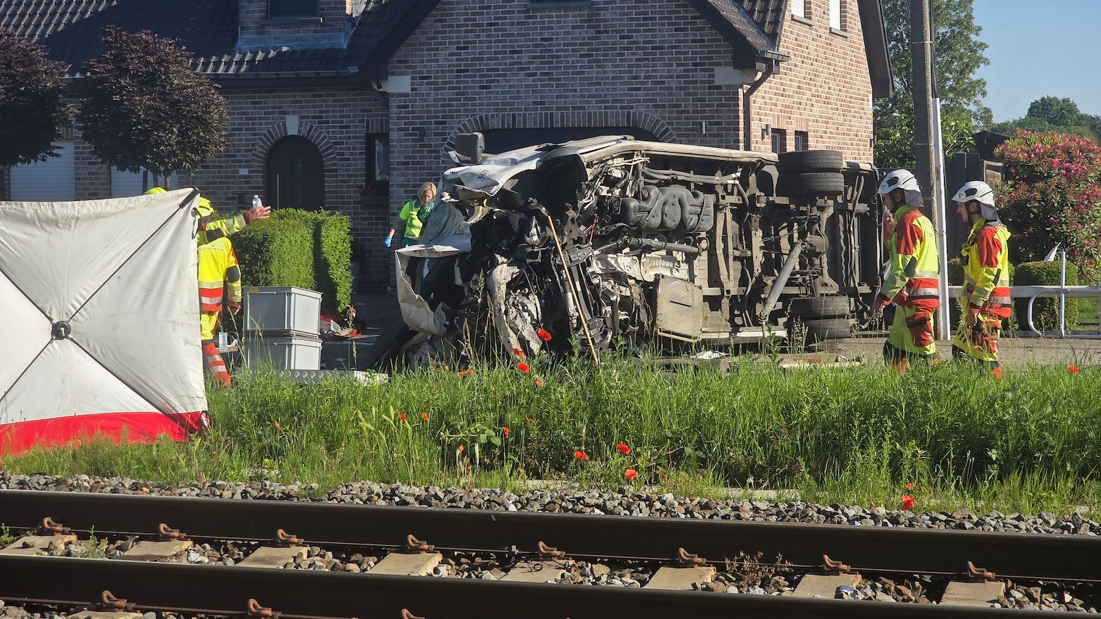 Several hurt in a crash between a train and a minibus, Belgian police say