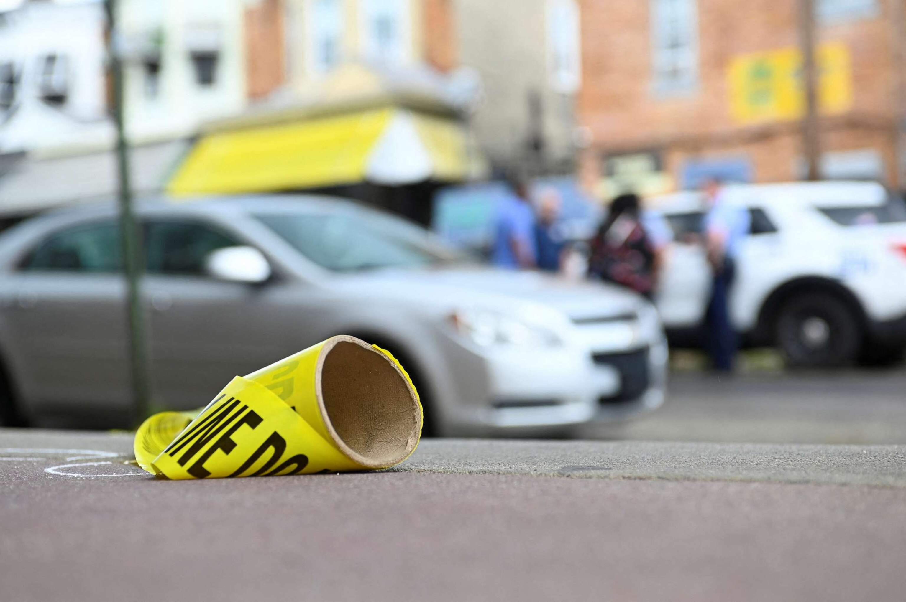 PHOTO: A police tape is seen as police officers work at the scene the day after a shooting on July 4, 2023.