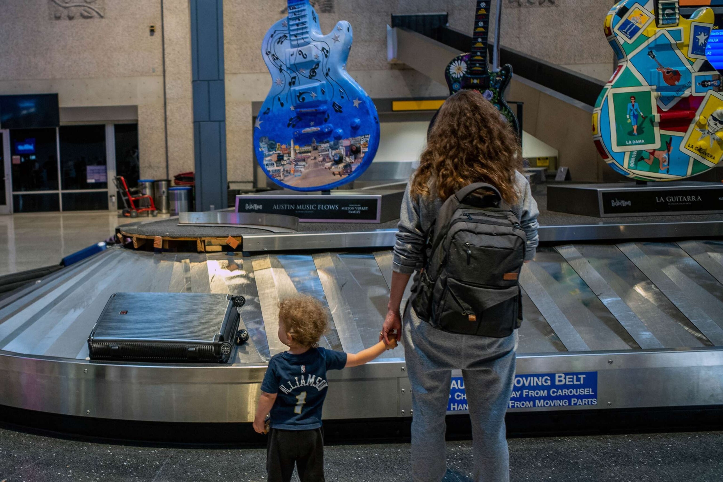 PHOTO: FILE - A family waits for their luggage at the Austin-Bergstrom International Airport, May 26, 2023 in Austin, Texas.