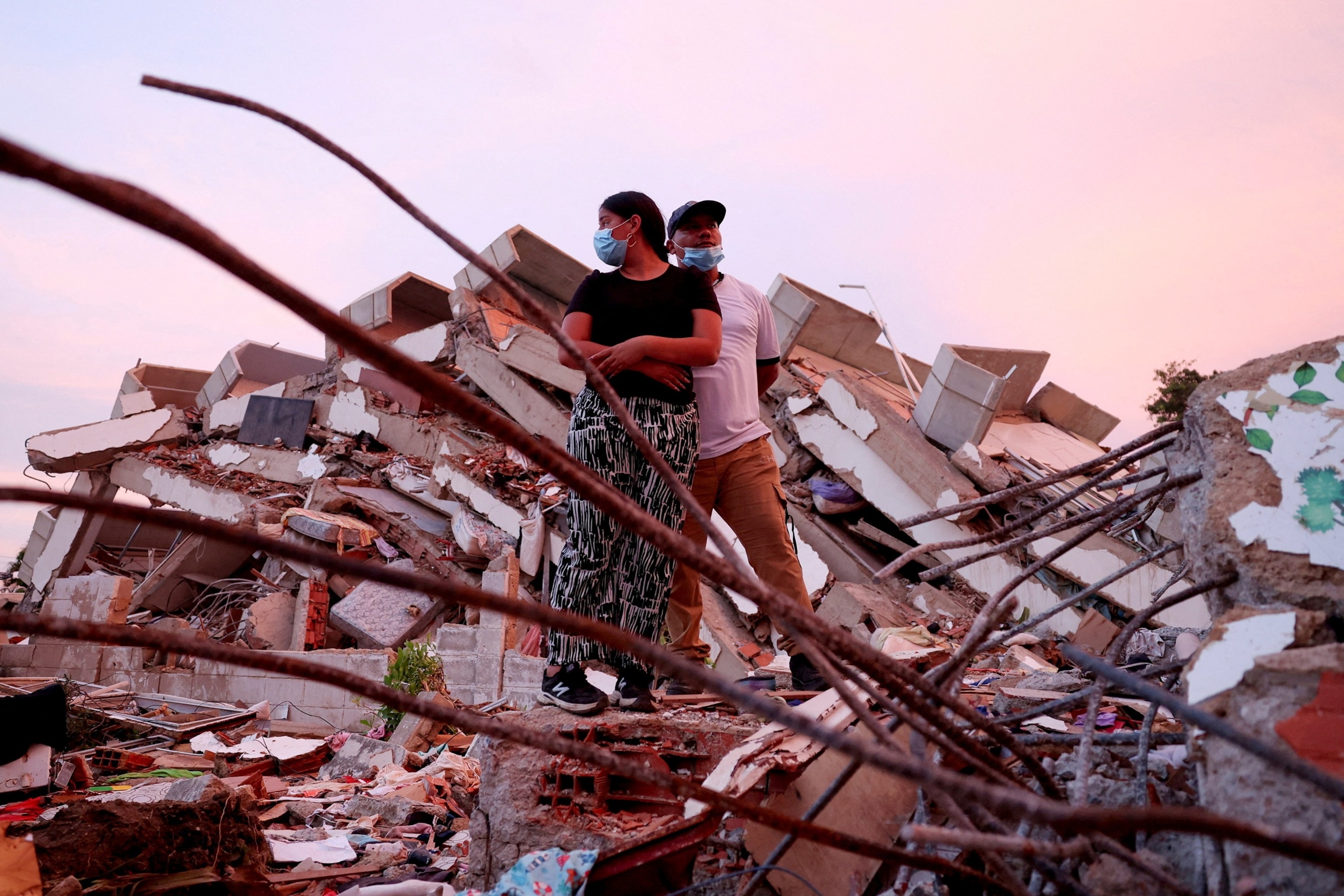 PHOTO: Yohancy Gil and her husband Sergio Guanipa wait for news from rescue teams looking for their children under the rubble at the site of a collapsed building in the aftermath of earthquakes, in La Guaira, Venezuela, June 30, 2026.