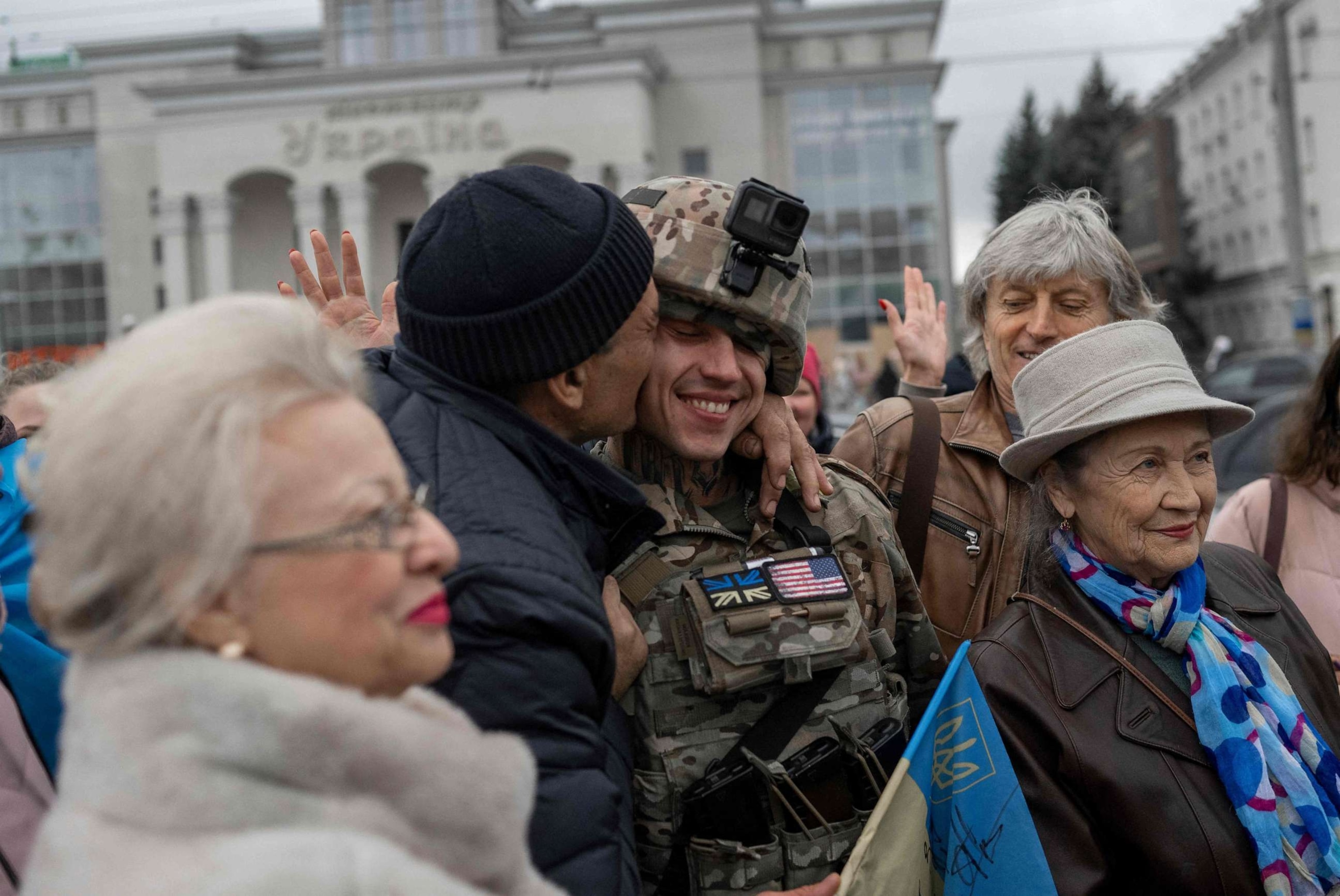 PHOTO: In this file photo taken on November 13, 2022 a man hugs a Ukrainian soldier as local residents gather to celebrate the liberation of Kherson, amid Russia's invasion of Ukraine.