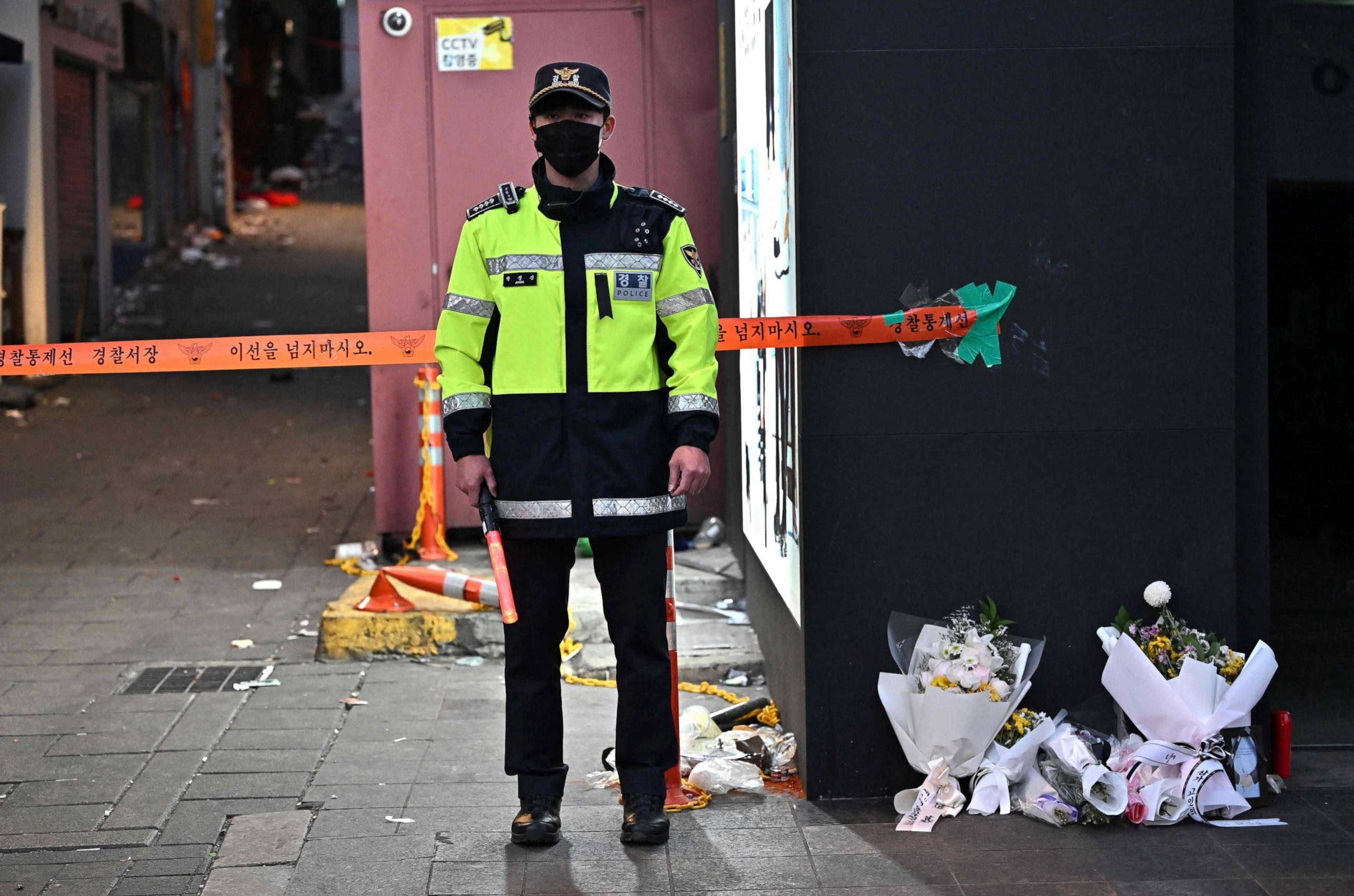 PHOTO: Police officer stands guard at the cordoned scene of the deadly Halloween crowd surge in the district of Itaewon in Seoul on November 1, 2022. 