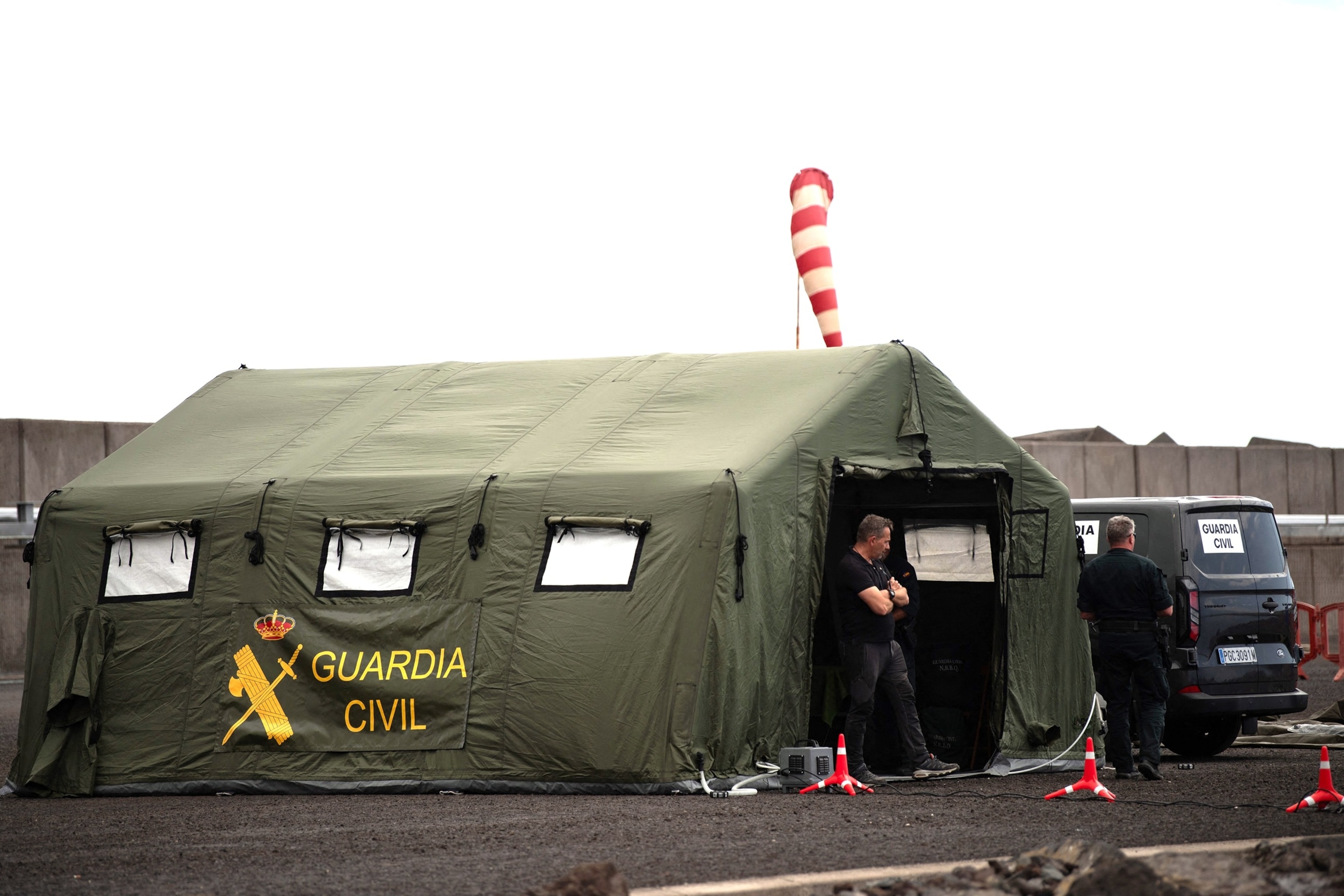 PHOTO: Members of the Spanish Civil Guard wait for the arrival of the Cruise MV Hondius at port of Granadilla de Abona on the island of Tenerife in Spain's Canary Islands on May 9, 2026.