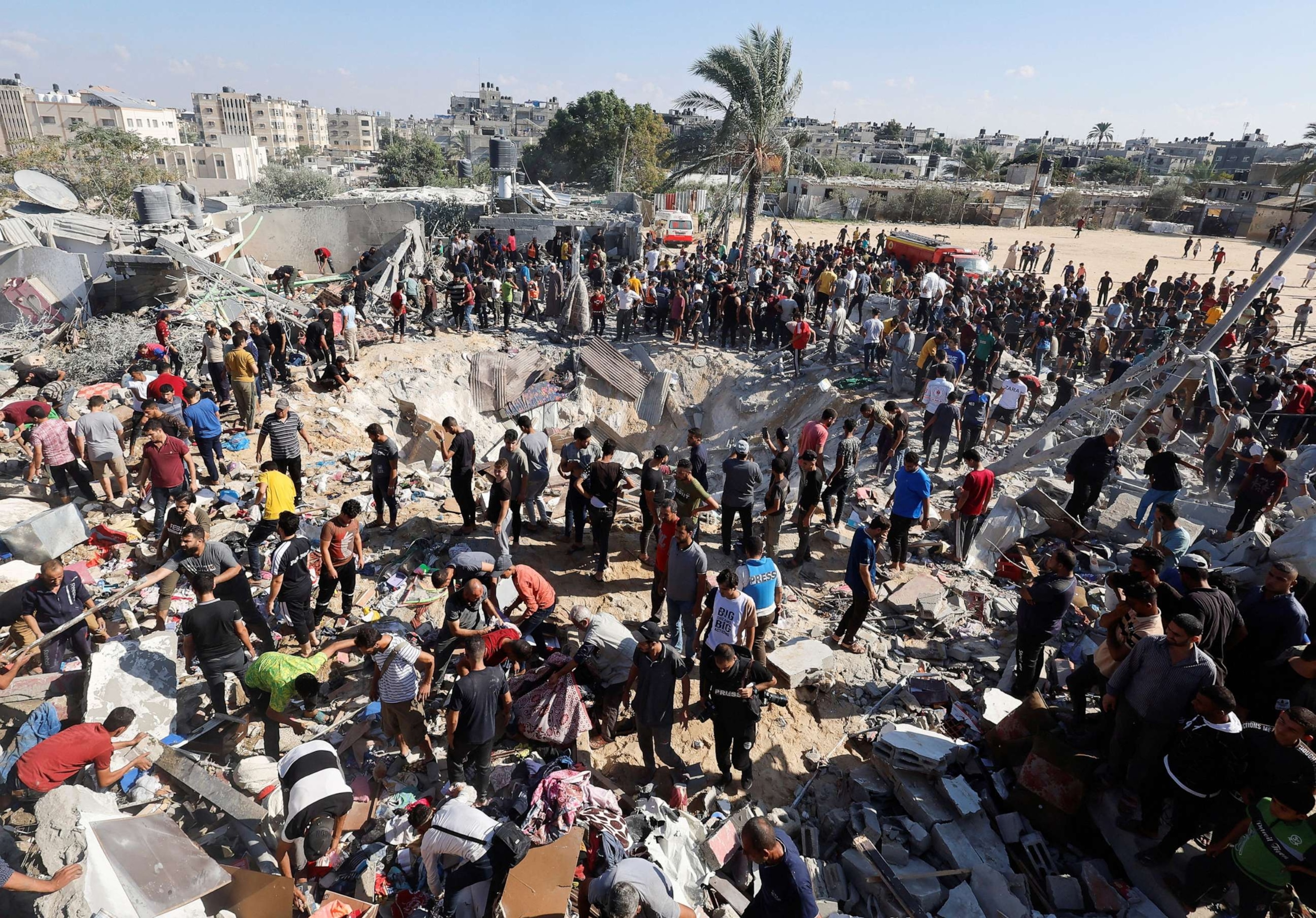 PHOTO: Palestinians search for casualties at the site of an Israeli strike on a house during the ongoing Israeli-Palestinian conflict, in Khan Younis in the southern Gaza Strip Oct. 19, 2023.