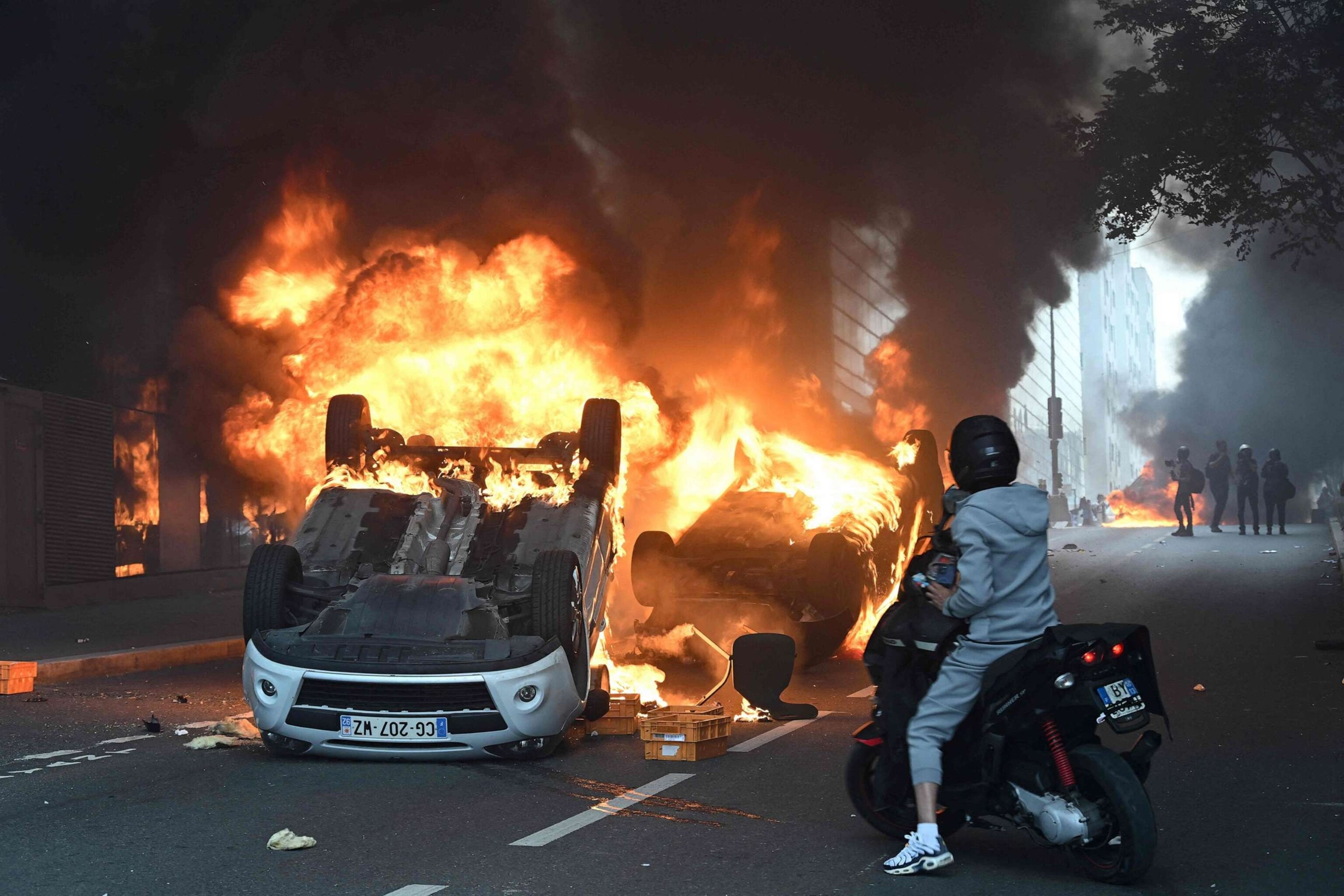 PHOTO: Cars burn in the street in the Paris suburb of Nanterrie, France, on June 29, 2023, following a commemoration march for 17-year-old Nahel M. who was shot dead by a police officer two days earlier.