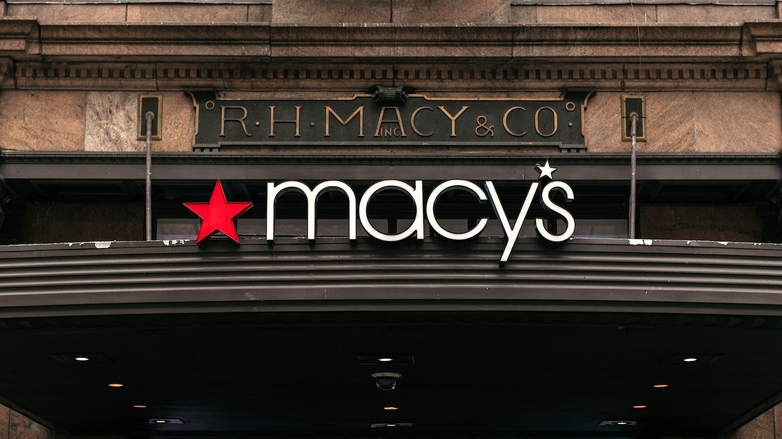 In this Feb. 25, 2020, file photo, signs for the Macy's flagship store are shown on 34th Street in Midtown Manhattan in New York.