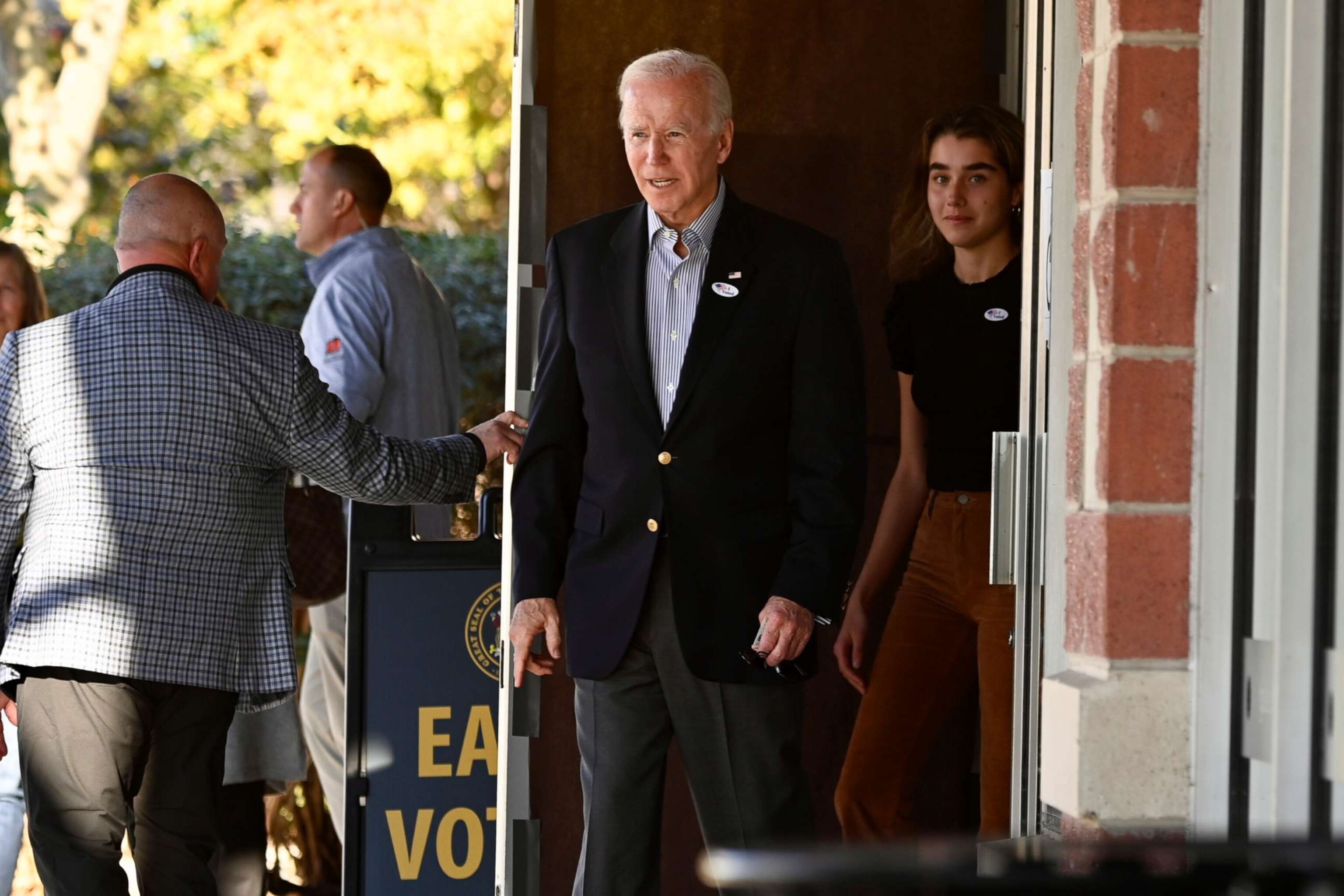 PHOTO: President Joe Biden exits a polling location after casting his ballot during early voting with his granddaughter, Natalie Biden, a first-time voter, in Wilmington, Del., Oct. 29, 2022.