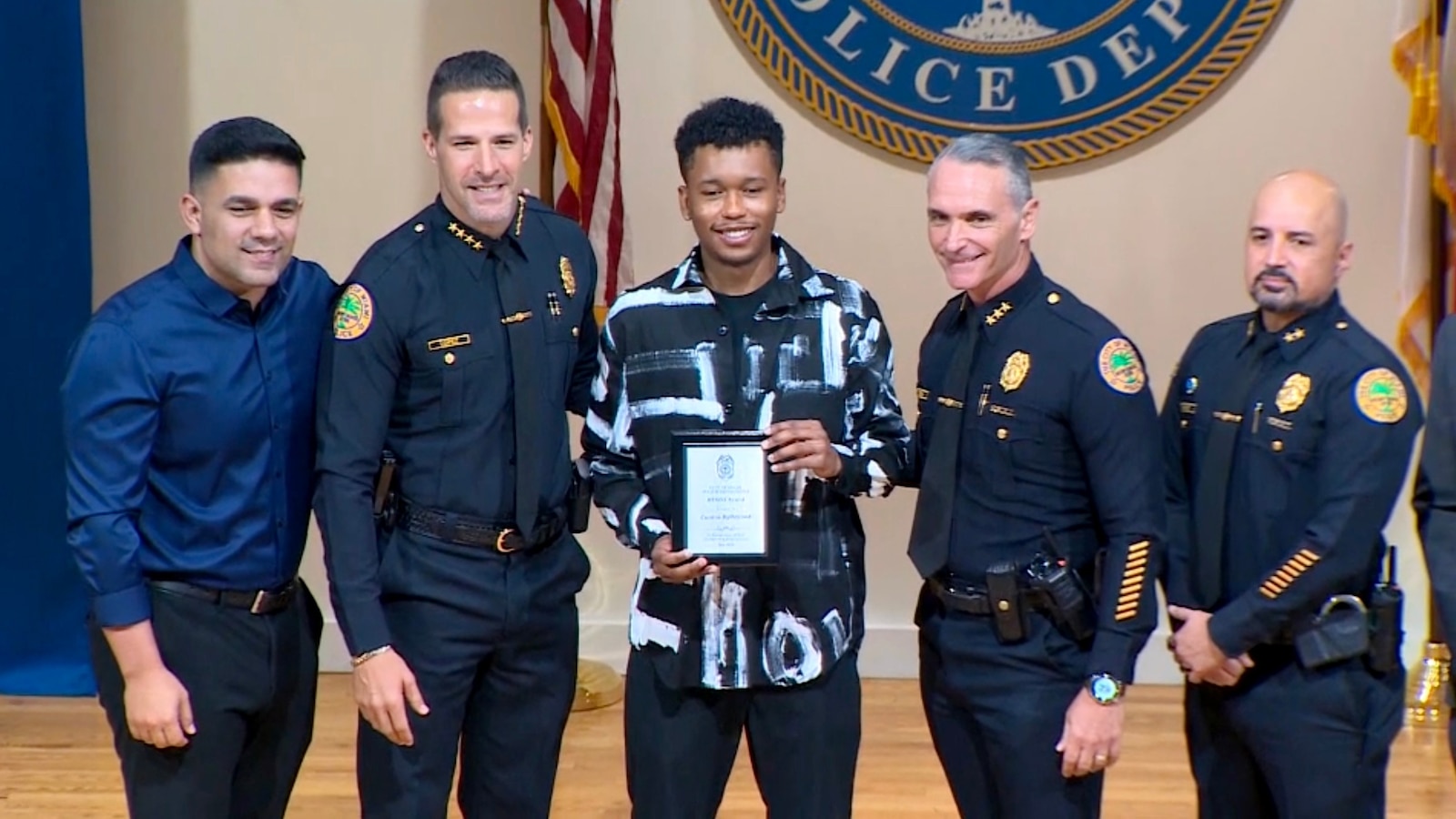 A 25-year-old man, who rescued a woman being violently assaulted in May, was recognized by Miami police with a hero award, according to authorities.