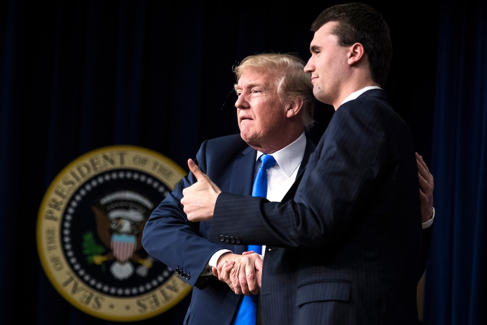PHOTO: In this March 22, 2018, file photo, President Donald Trump shakes hands with Charlie Kirk, Founder and Executive Director of Turning Point USA, during a panel discussion at the Generation Next Summit in Washington, D.C.