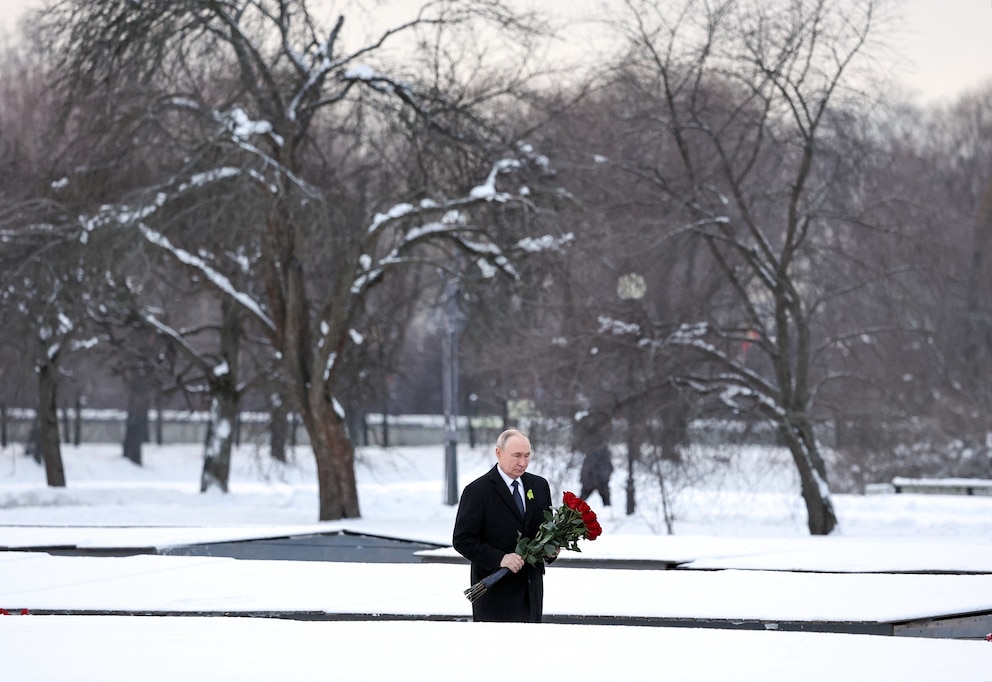 PHOTO: In this pool photograph distributed by the Russian state agency Sputnik, Russia's President Vladimir Putin lays flowers at the grave of his brother at Piskaryovskoye Memorial Cemetery in Saint Petersburg on Jan. 27, 2026.