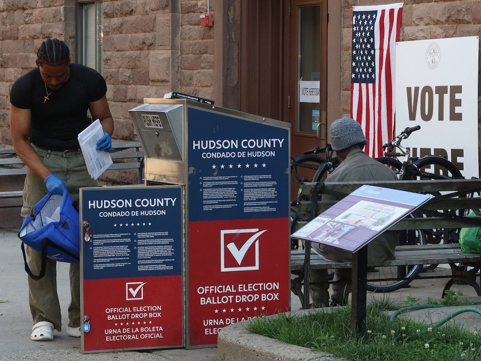 PHOTO: A  poll worker collects mail in ballots from a drop box for the New Jersey primary election, June 4, 2024, in Hoboken, New Jersey.  