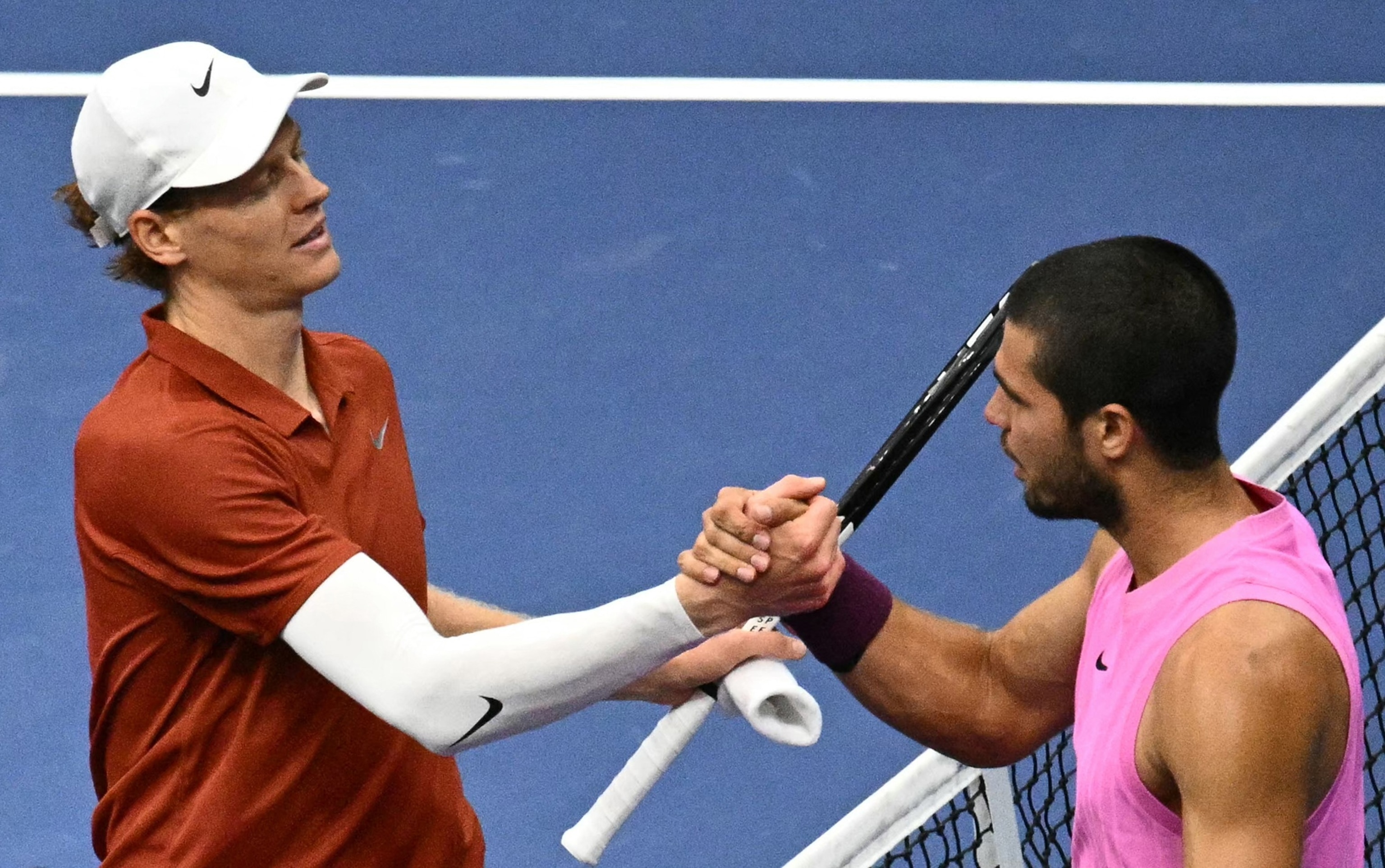 PHOTO: Italy's Jannik Sinner and Spain's Carlos Alcaraz shake hands at the net after alcaraz won the men's singles final tennis match on day fifteen of the US Open tennis tournament at the USTA Billie Jean King National Tennis Center, Sept. 7, 2025.