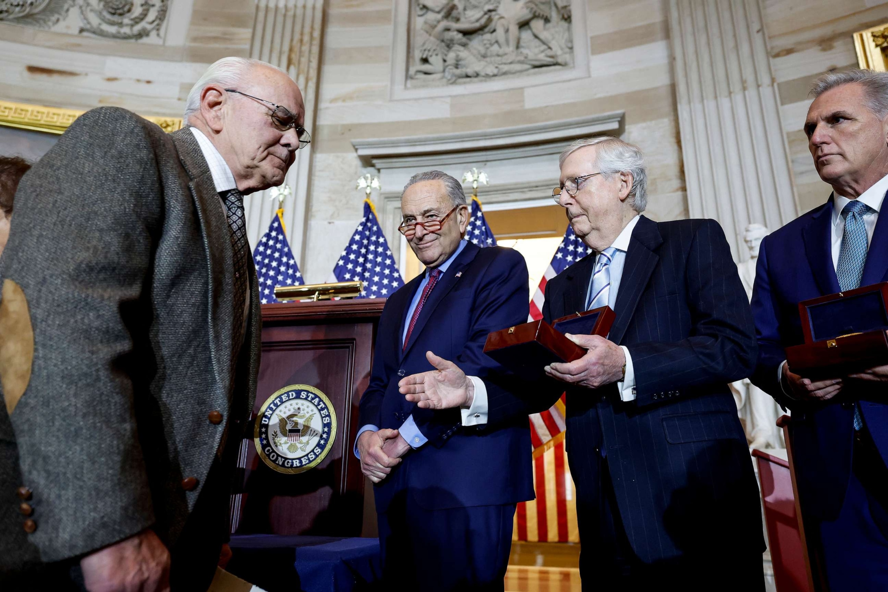 PHOTO: Senate Minority Leader Mitch McConnell (R-KY) holds out his hand for a handshake with Charles Sicknick, the father of Capitol Police officer Brian Sicknick, at the U.S. Capitol, Dec. 6, 2022, in Washington.