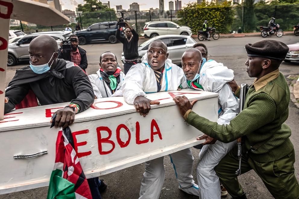 PHOTO: Activists push against Kenyan police officers as they attempt to enter the Ministry of Health carrying a mock coffin during a protest against a US-built Ebola quarantine center planned at Kenya's Laikipia Air Base, in Nairobi on June 2, 2026.
