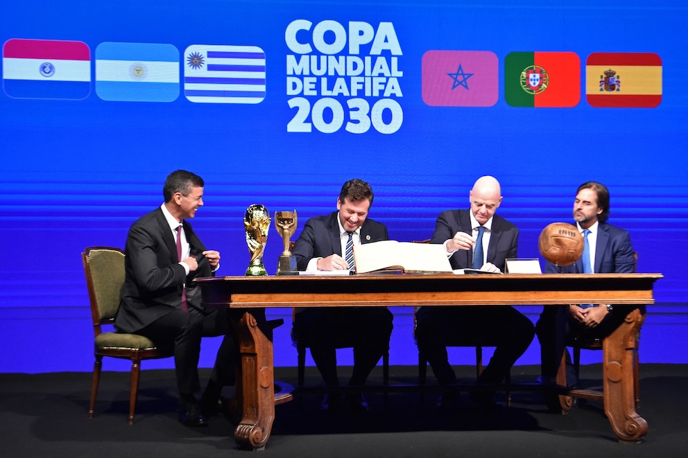 PHOTO: Conmebol's President Alejandro Dominguez and FIFA President Gianni Infantino accompanied by Paraguay's President Santiago Pena and Uruguay's President Luis Lacalle sign a book of minutes of the 2030 World Cup in Luque, Paraguay, April 11, 2024.