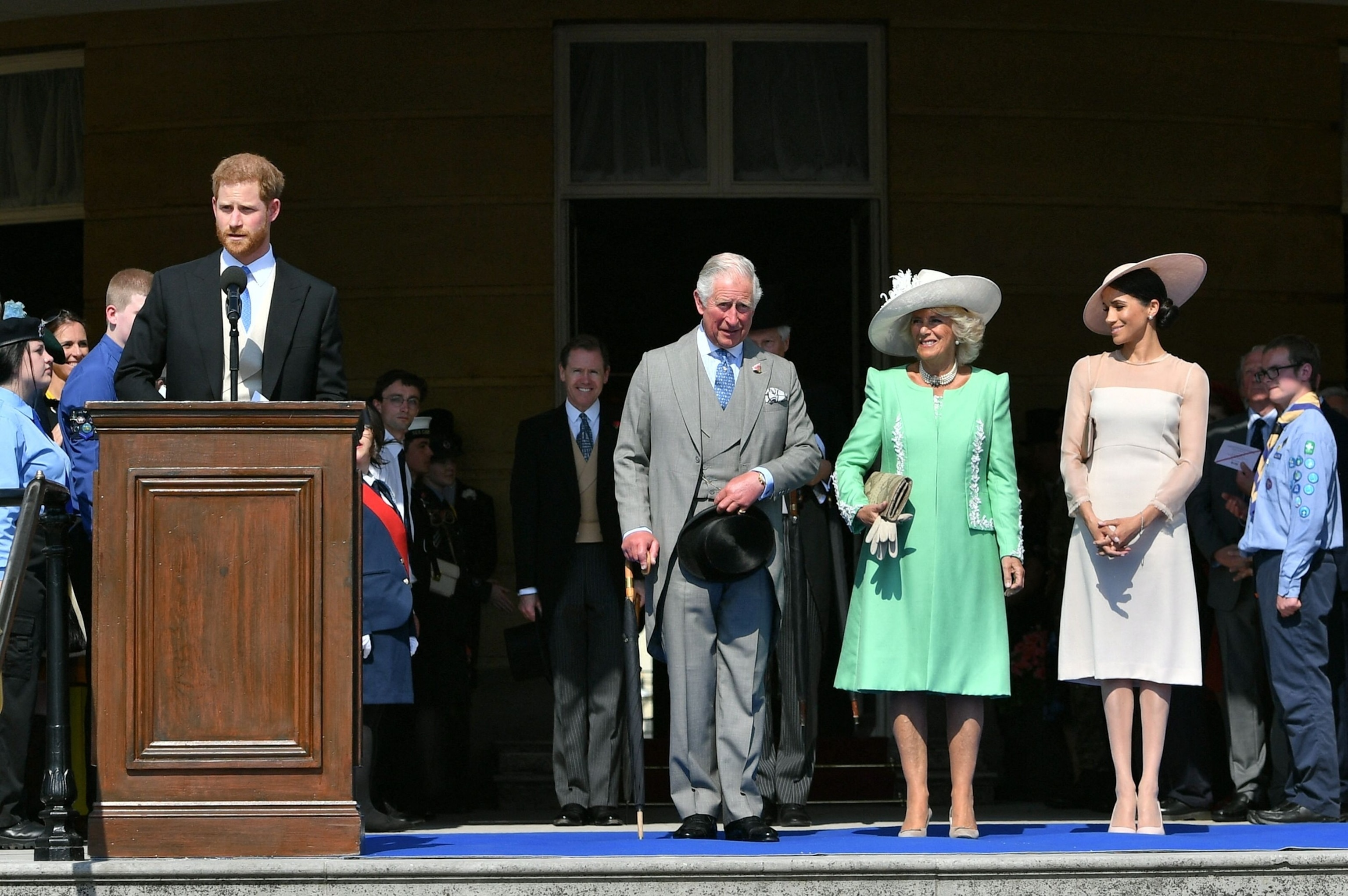PHOTO: Britain's Prince Charles, Prince of Wales (C) and his wife Britain's Camilla, Duchess of Cornwall (2R), talk with Britain's Meghan, Duchess of Sussex (R), as her husband Britain's Prince Harry, Duke of Sussex speaks on May 22, 2018. 