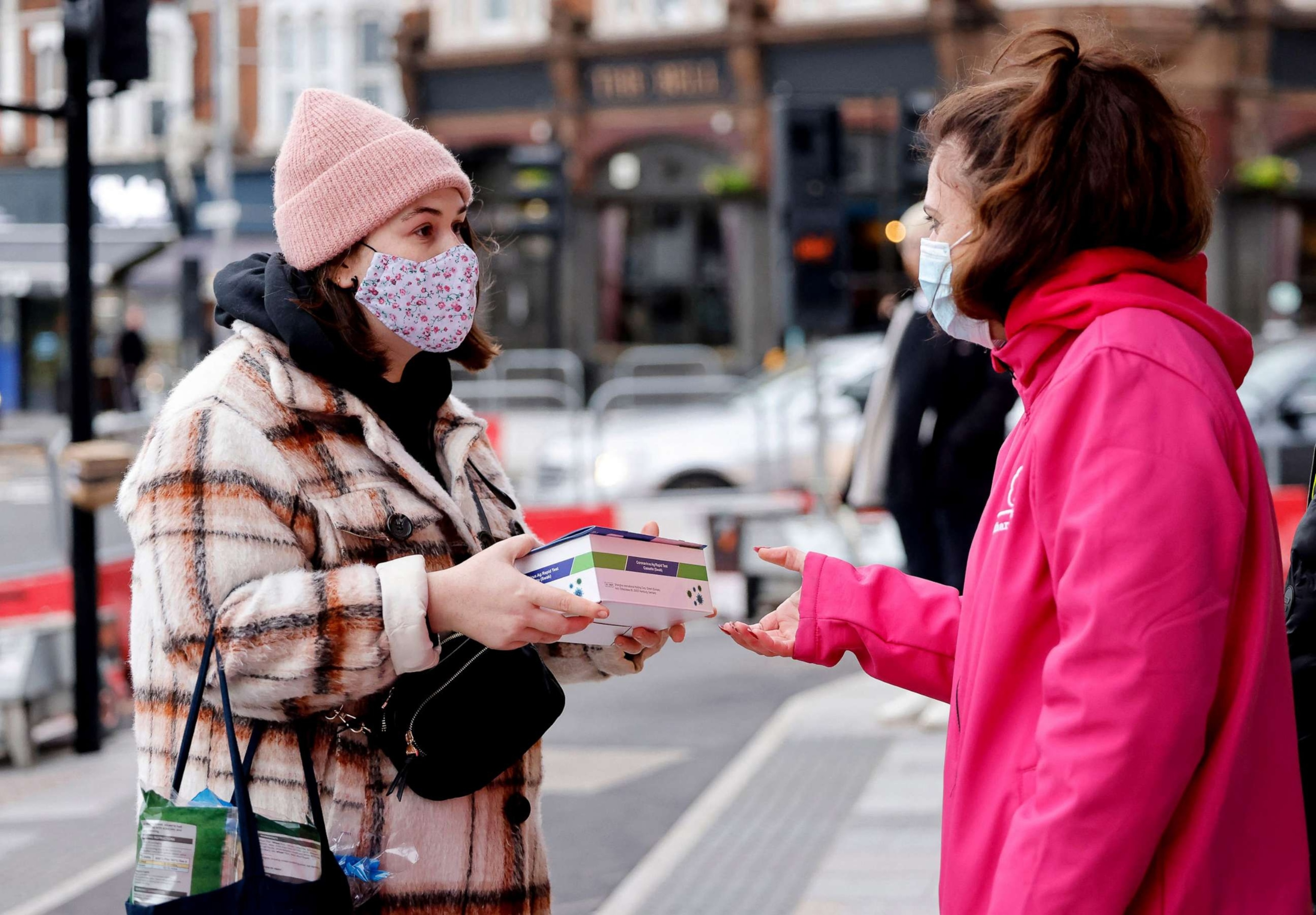 PHOTO: Volunteers hand out boxes of Covid-19 rapid antigen Lateral Flow Tests in London, Jan. 3, 2022.