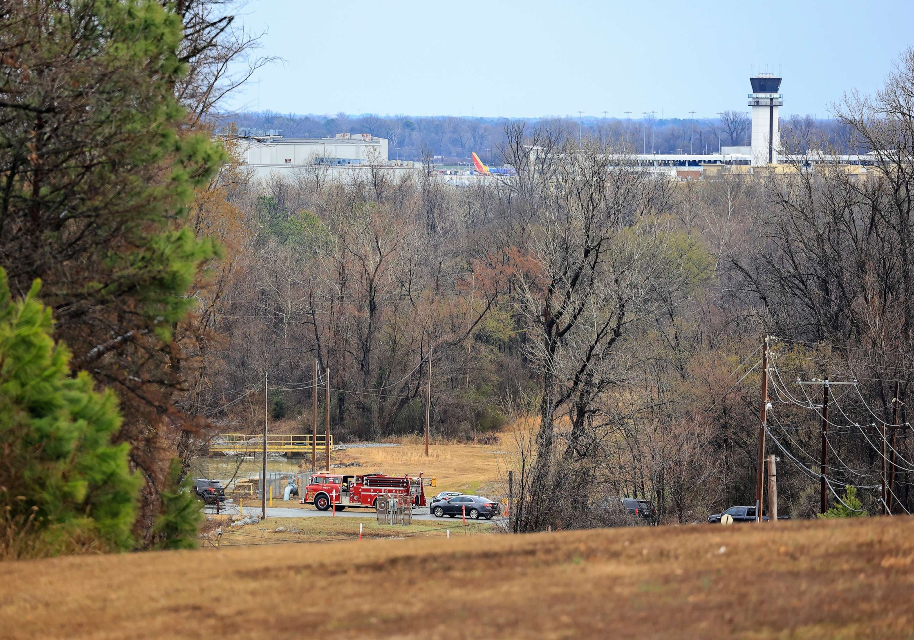 PHOTO: Emergency vehicles appear near the location where a small aircraft crashed while taking off from the Bill and Hillary Clinton National Airport in Little Rock, Ark., Feb. 22, 2023.