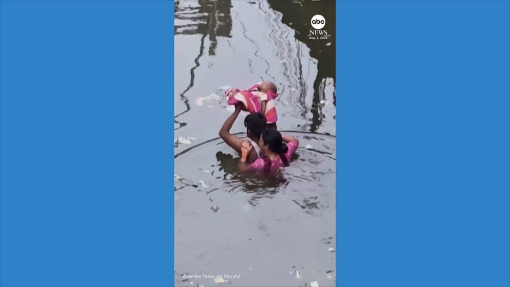 NextImg:Video Man carries baby through floodwater as severe rain hits India
