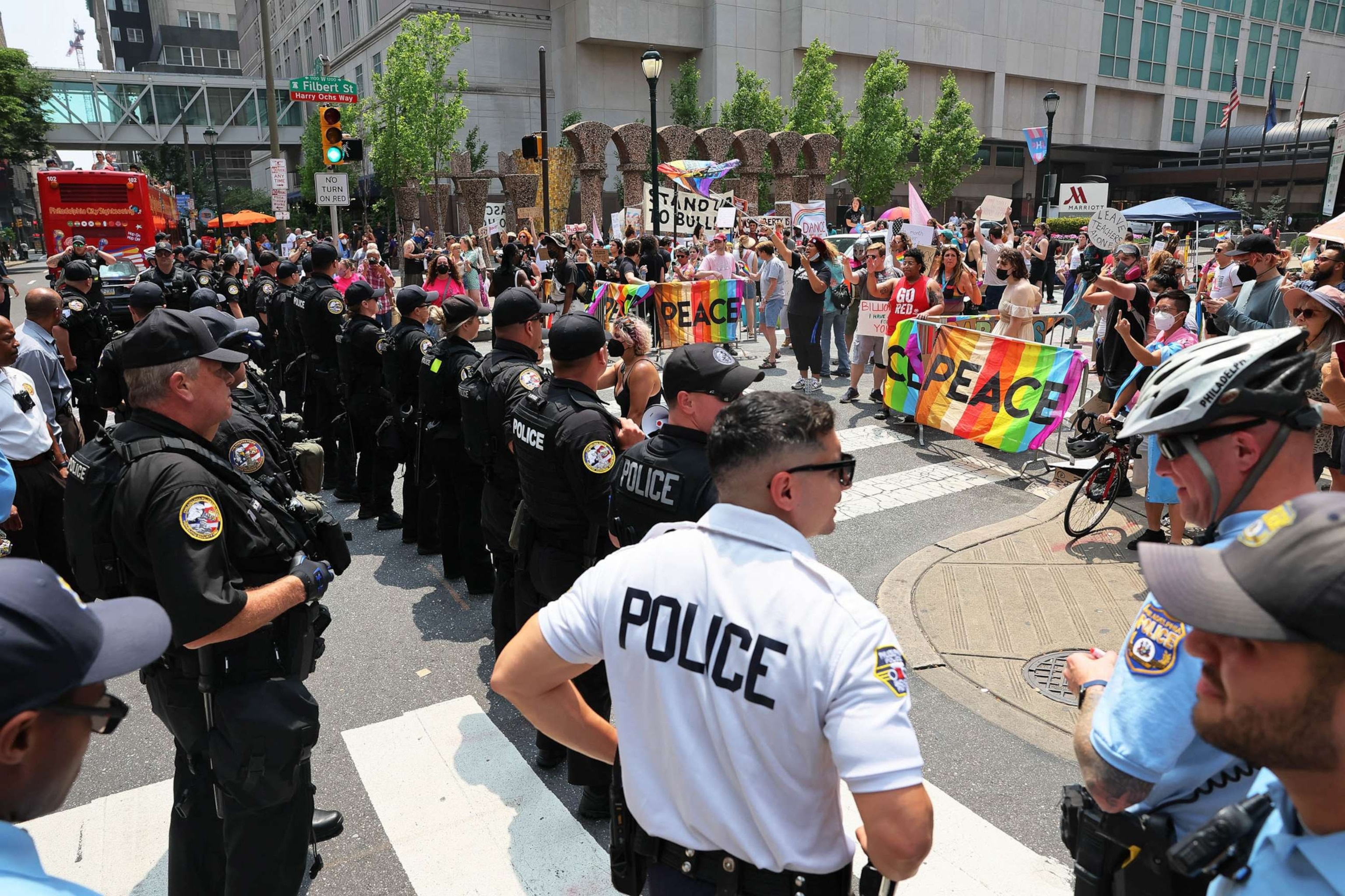 PHOTO: FILE - Philadelphia police officers stand guard as people protest the Moms for Liberty Joyful Warriors national summit outside the Philadelphia Marriott Downtown, July 1, 2023 in Philadelphia.