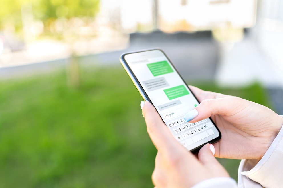 PHOTO: Woman sending text message with cellphone.