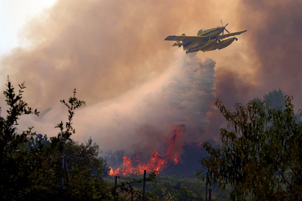 PHOTO: An Air Tractor AT-802F Fire Boss aircraft dumps water over a wildfire burning near San Martín de Valdeiglesias west of Madrid, July 26, 2026.