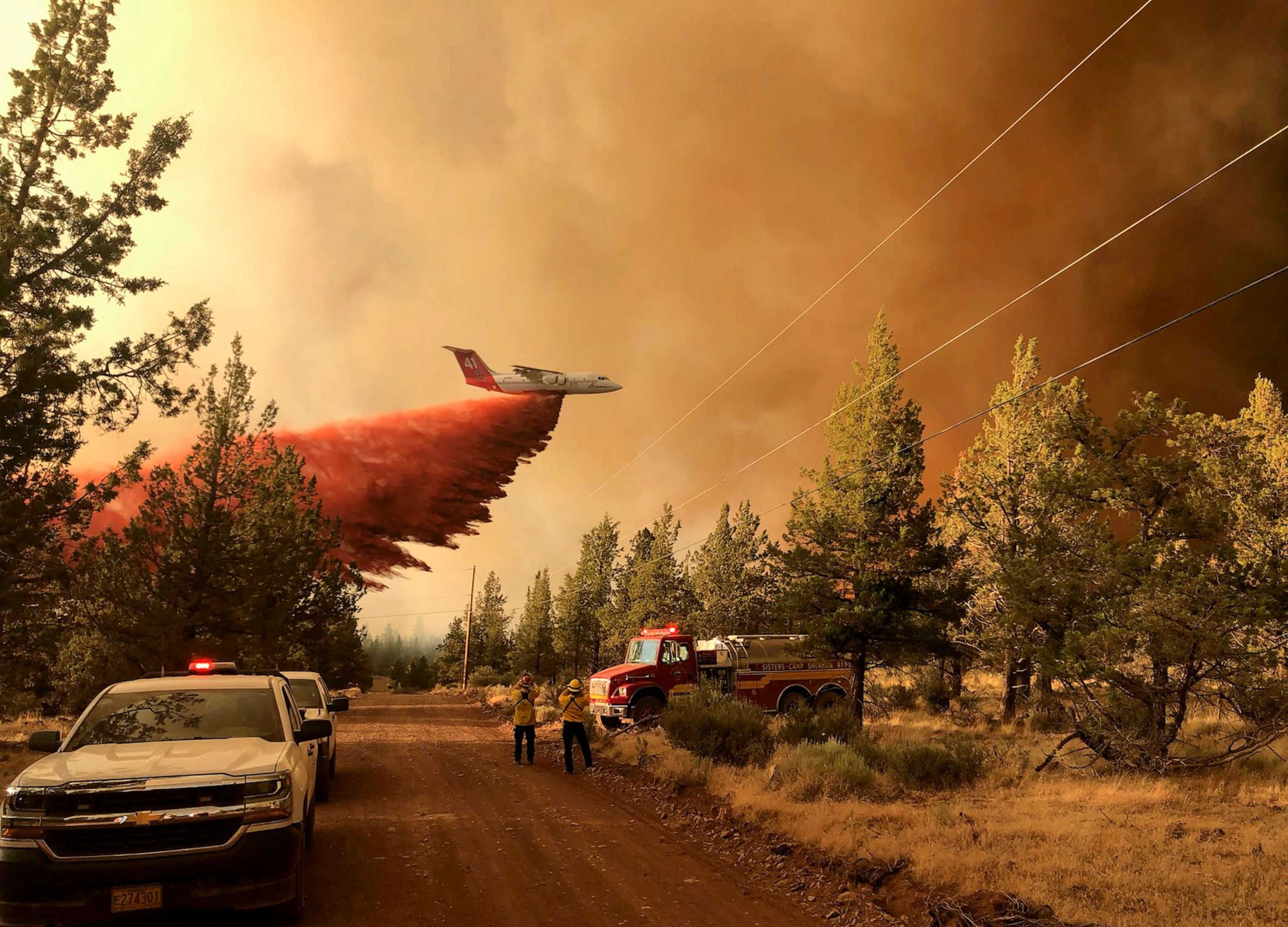 PHOTO: A firefighting tanker makes a retardant drop over the Grandview Fire near Sisters, Ore., July 11, 2021.