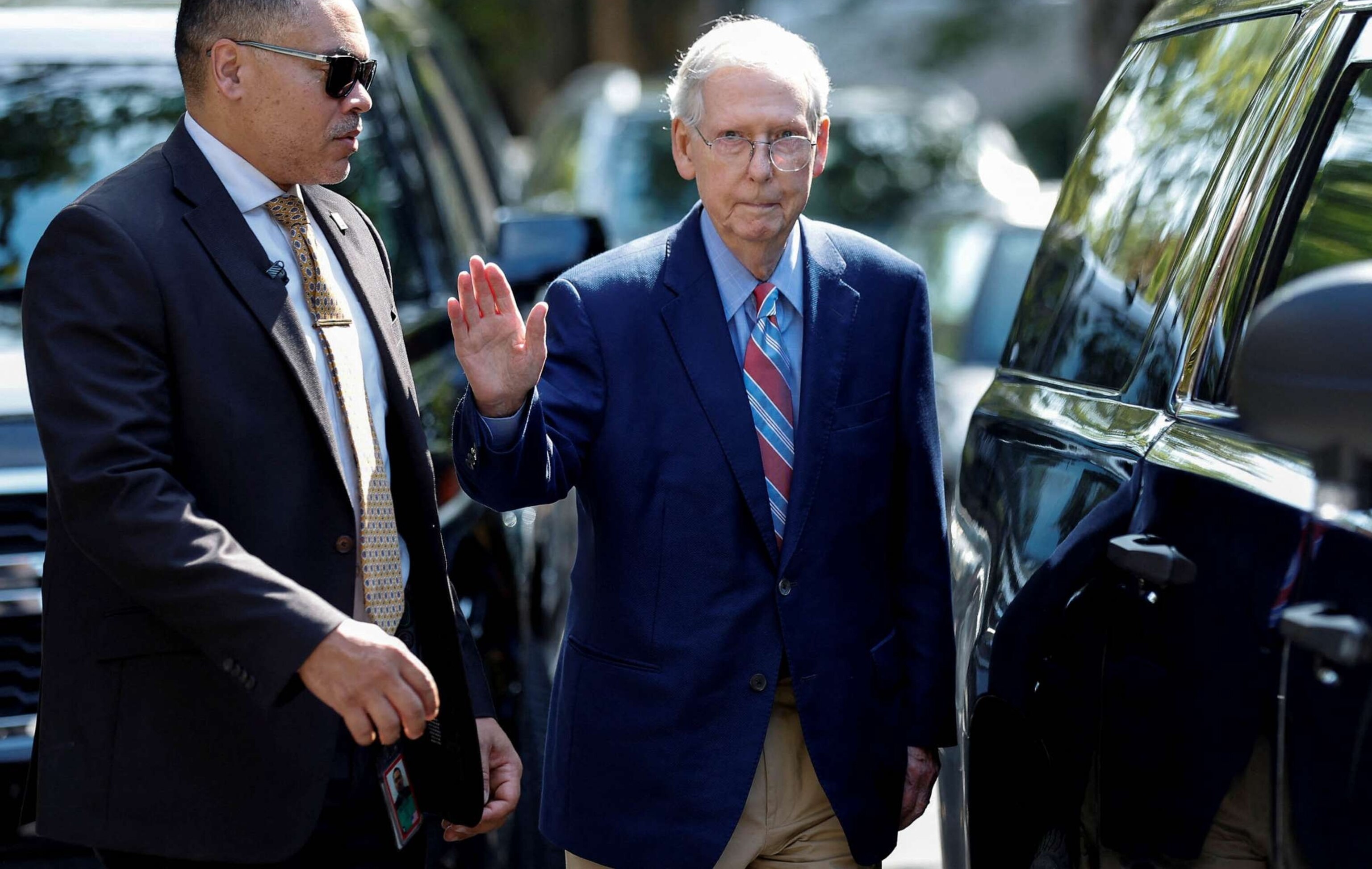 PHOTO: Senate Minority Leader Mitch McConnell waves as he leaves his Washington house to return to work at the U.S. Senate, less than a week after he froze for more than 30 seconds while speaking to reporters at an event in his home state of Kentucky