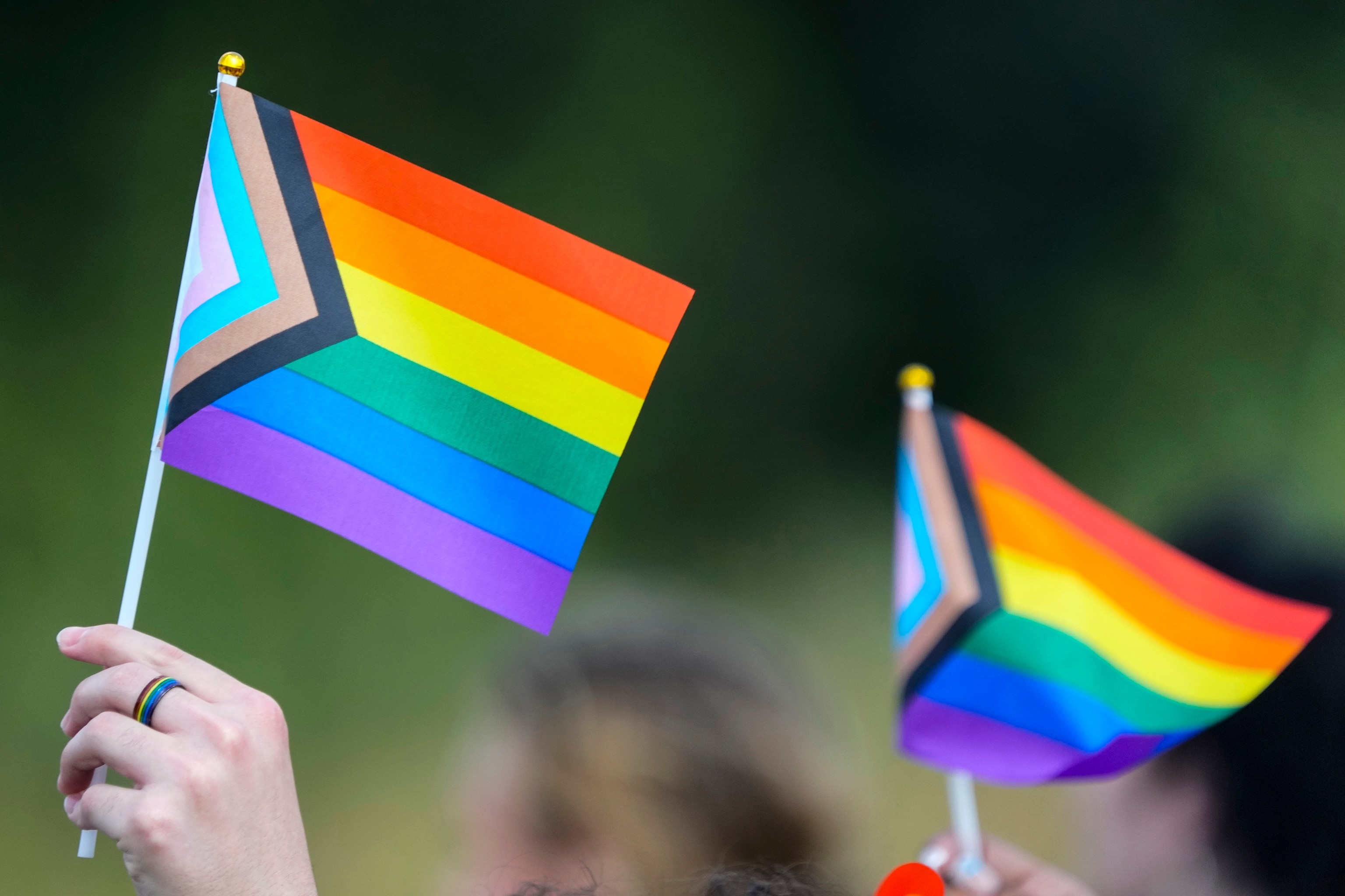 PHOTO: Students hold flags as they protest against Katy ISD's new transgender policy outside the school district's educational support complex, Aug. 30, 2023, in Katy, Texas. 