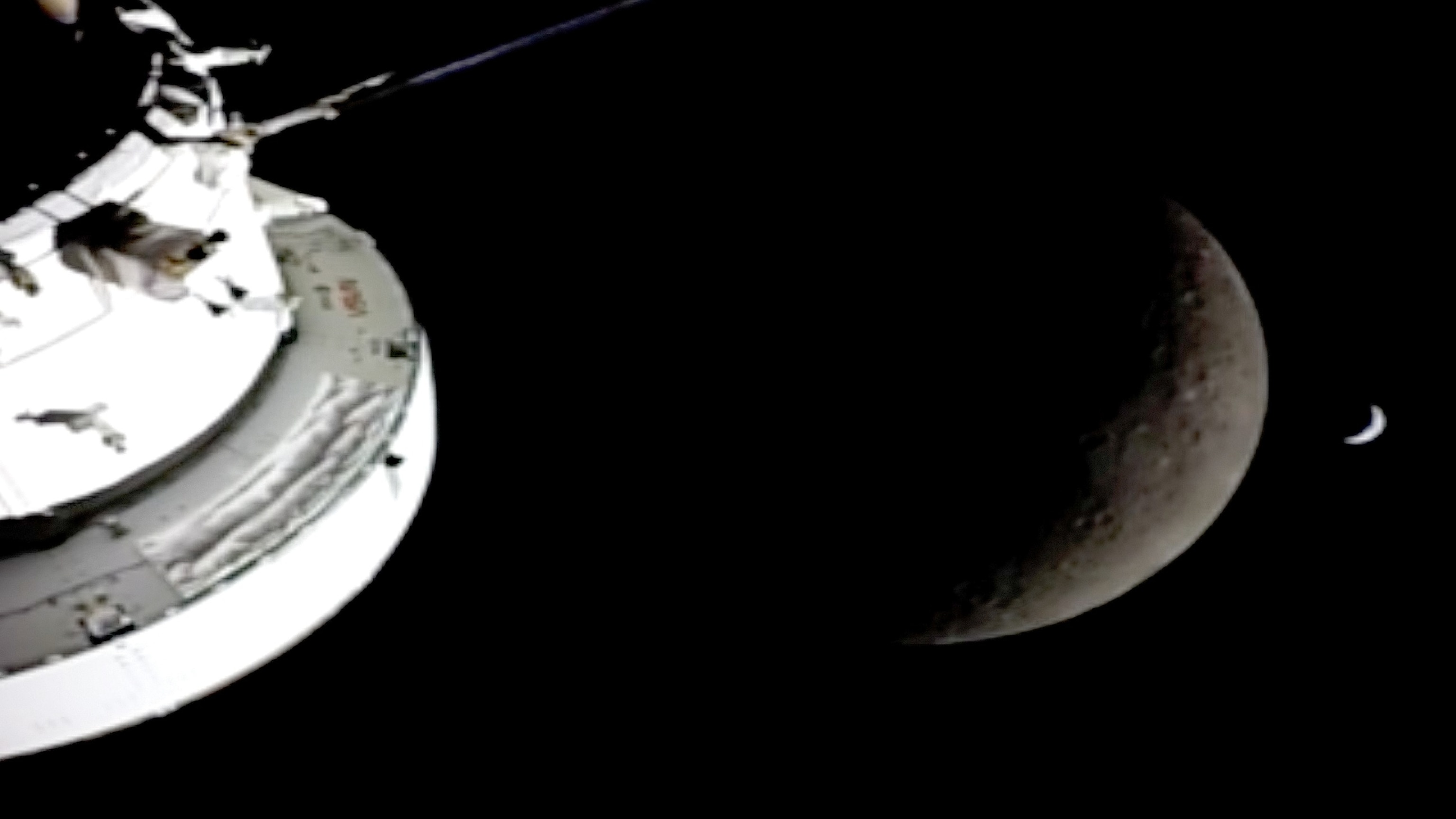 PHOTO: A crescent shaped Earth is seen behind the Moon as seen just before the Orion spacecraft flew on the back side of the Moon, April 6, 2026.