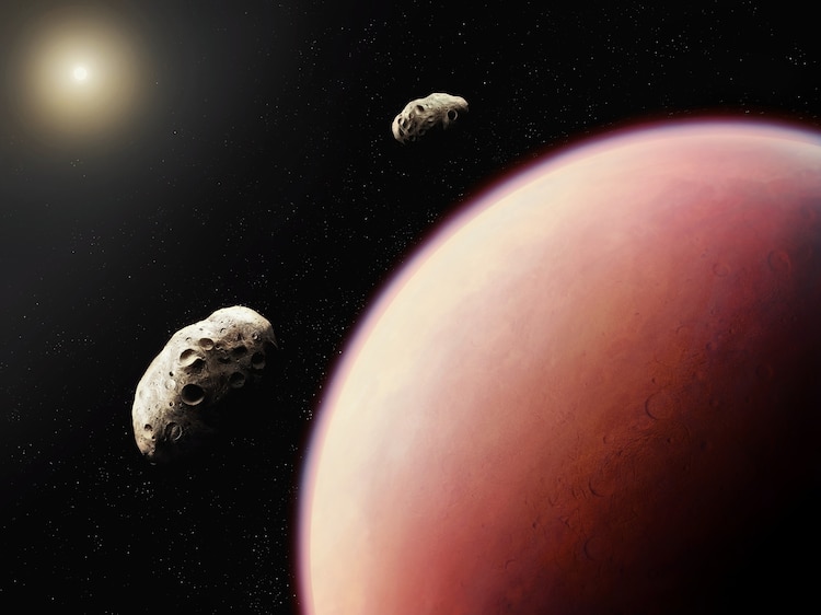 PHOTO: Phobos and Deimos over the surface of Mars.