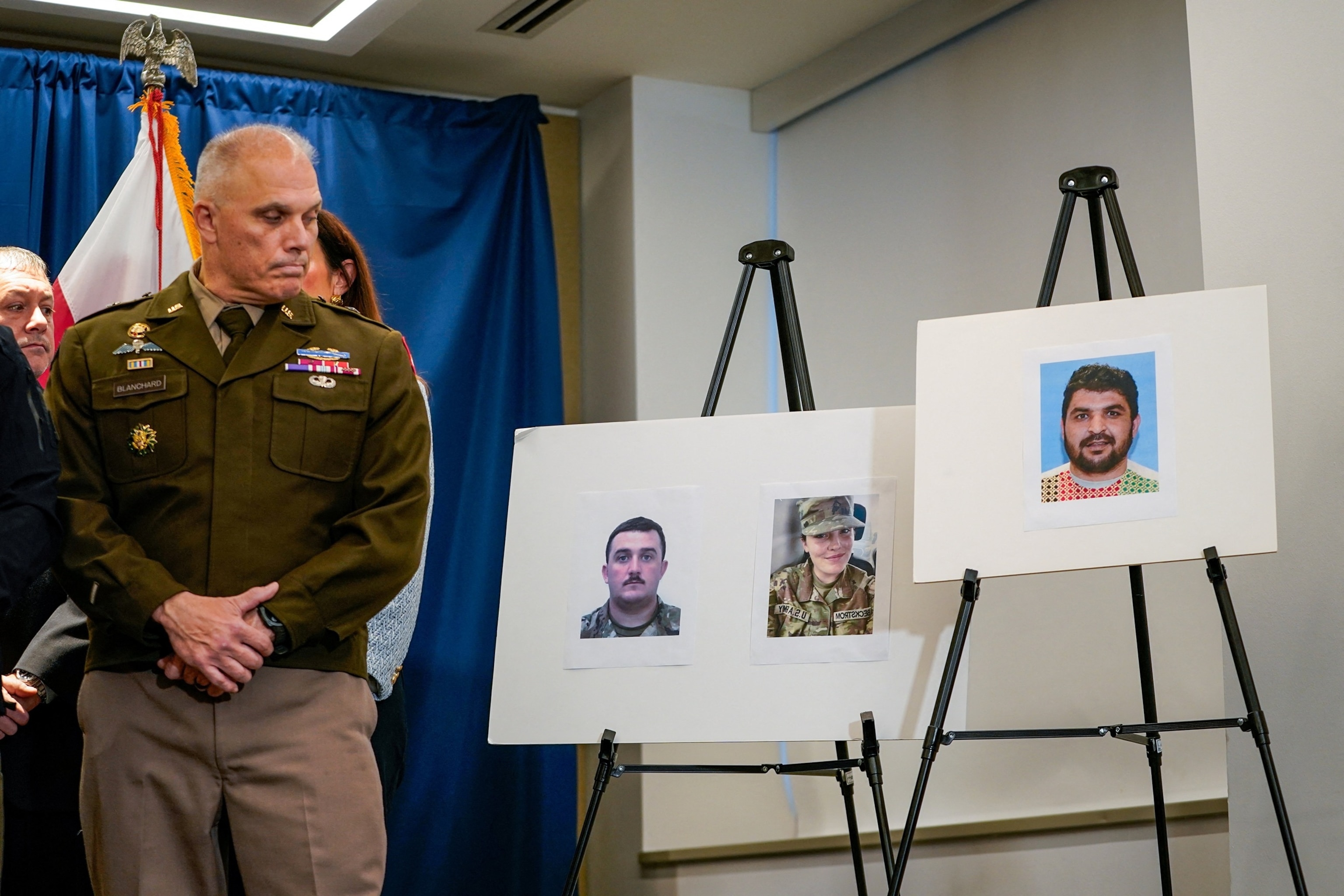 PHOTO: Brigadier General Leland D. Blanchard II looks towards pictures of two National Guard members who were shot along with a picture of a suspect, Afghan national Rahmanullah Lakanwal, at a press conference in Washington, D.C., Nov. 27, 2025.