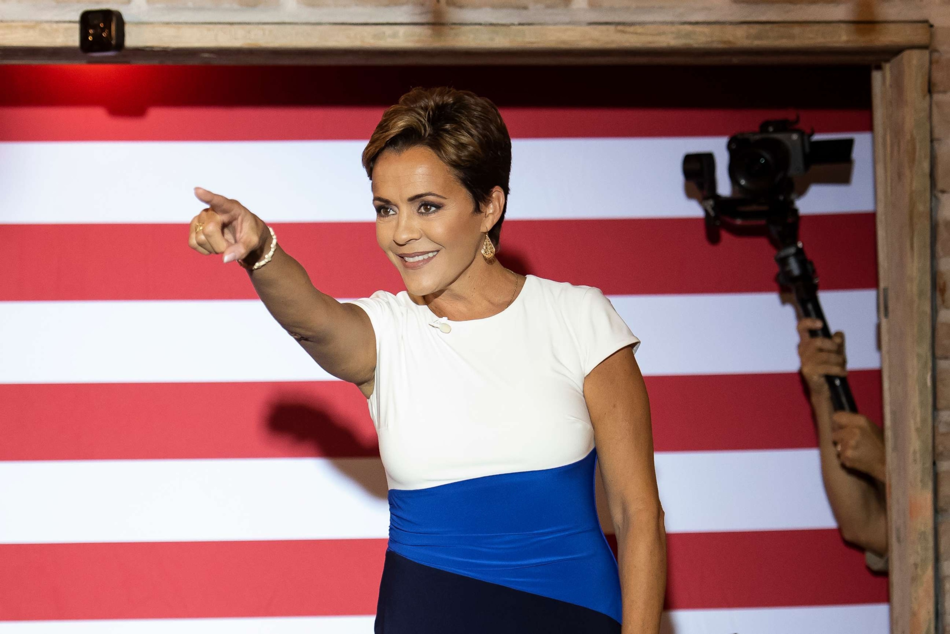 PHOTO: Arizona Republican nominee for governor Kari Lake greets the audience during a stop on her Ask Me Anything Tour at American Way Market, Sept. 20, 2022, in Chandler, Ariz.