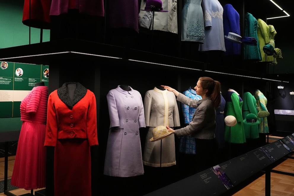 PHOTO: A member of the Royal Collection Trust adjusts day wear worn by Queen Elizabeth II, on display at 'Queen Elizabeth II: Her Life in Style' exhibition at The King's Gallery at Buckingham Palace in London, April 9, 2026.