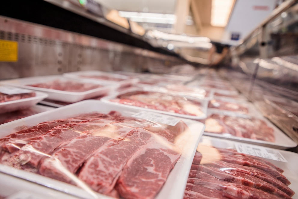 PHOTO: low angle view of variety of tray packing meat on the supermarket freezer