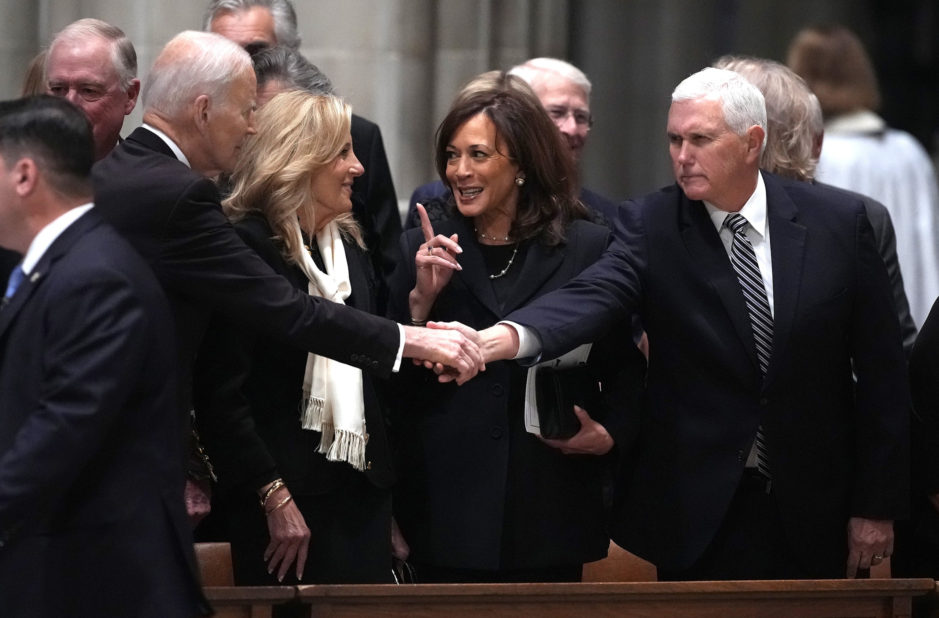 PHOTO: Former President Joe Biden shakes hands with former Vice President Mike Pence as former first lady Jill Biden talks with former Vice President Kamala Harris at the funeral service of former Vice President Dick Cheney, Nov. 20, 2025 in Washington.