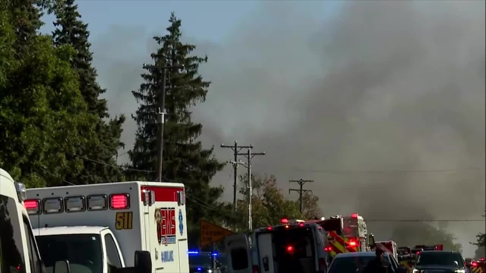 PHOTO: Smoke rises in the distance from a fire set, September 28, 2025, during a mass shooting at The Church of Jesus Christ of Latter-day Saints in Grand Blanc, Michigan