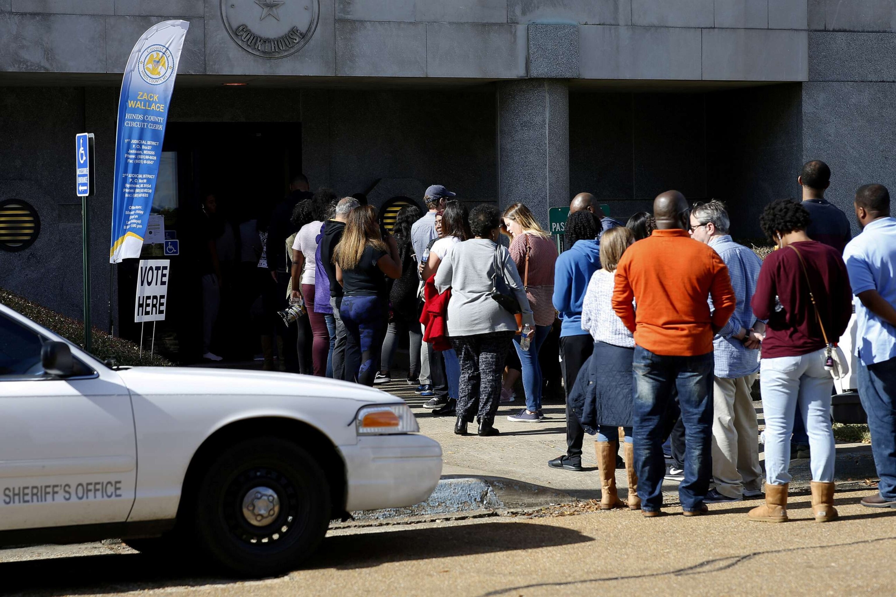 PHOTO: In this Nov. 24, 2018, file photo, voters wait in line to cast their absentee ballots in Jackson, Miss.