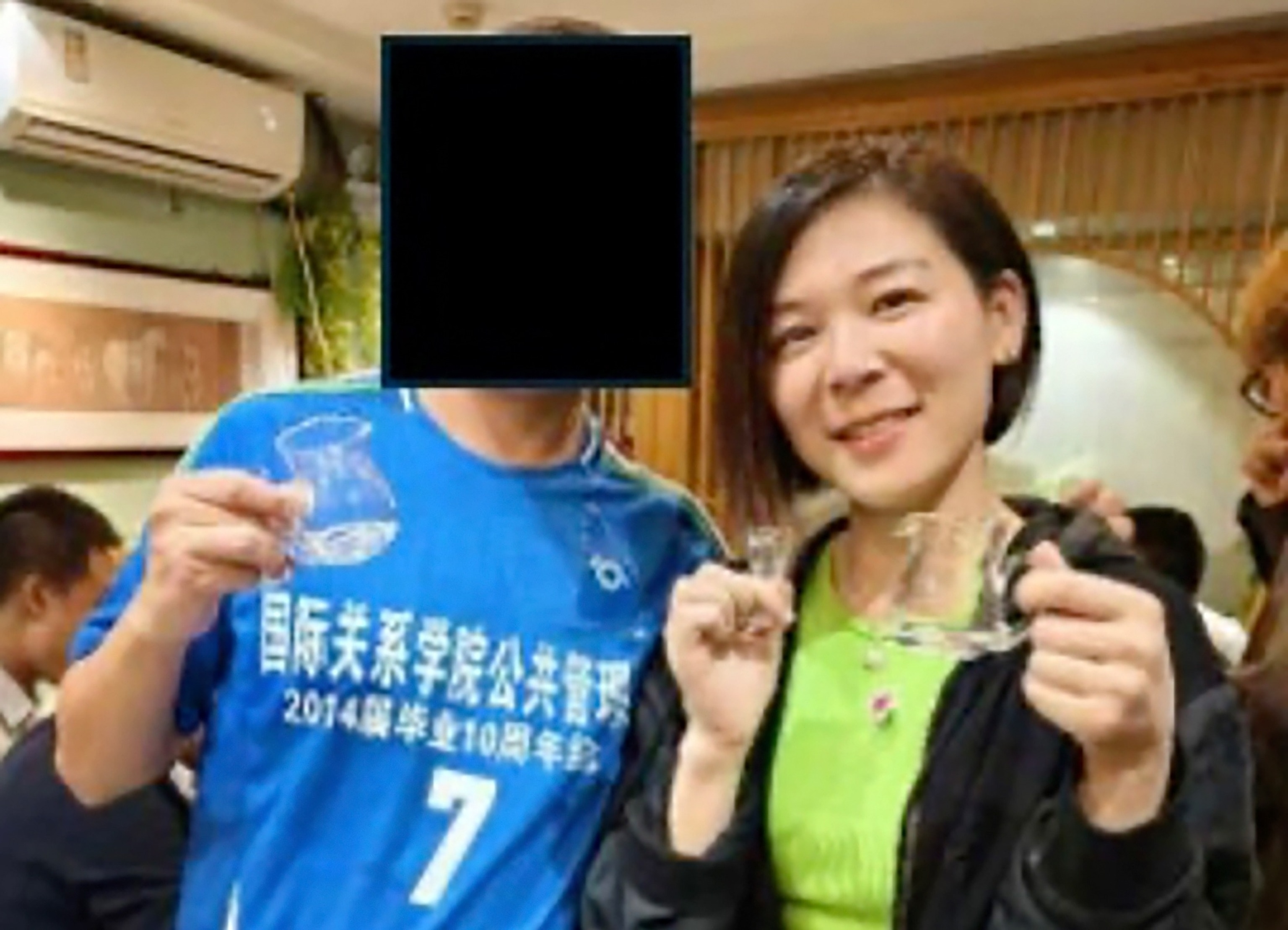 PHOTO: Wanying Zhang, who was charged with allegedly spying on the Taiwanese President's son and family, with an unidentified member of the Chinese communist party. 