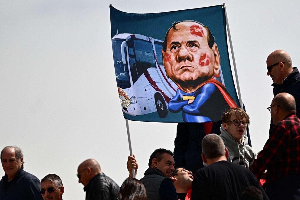PHOTO: Spectators in a tribune display a banner with a caricature of former Italian prime minister and current president of AC Monza, Silvio Berlusconi on May 14, 2023 at the Brianteo stadium in Monza.