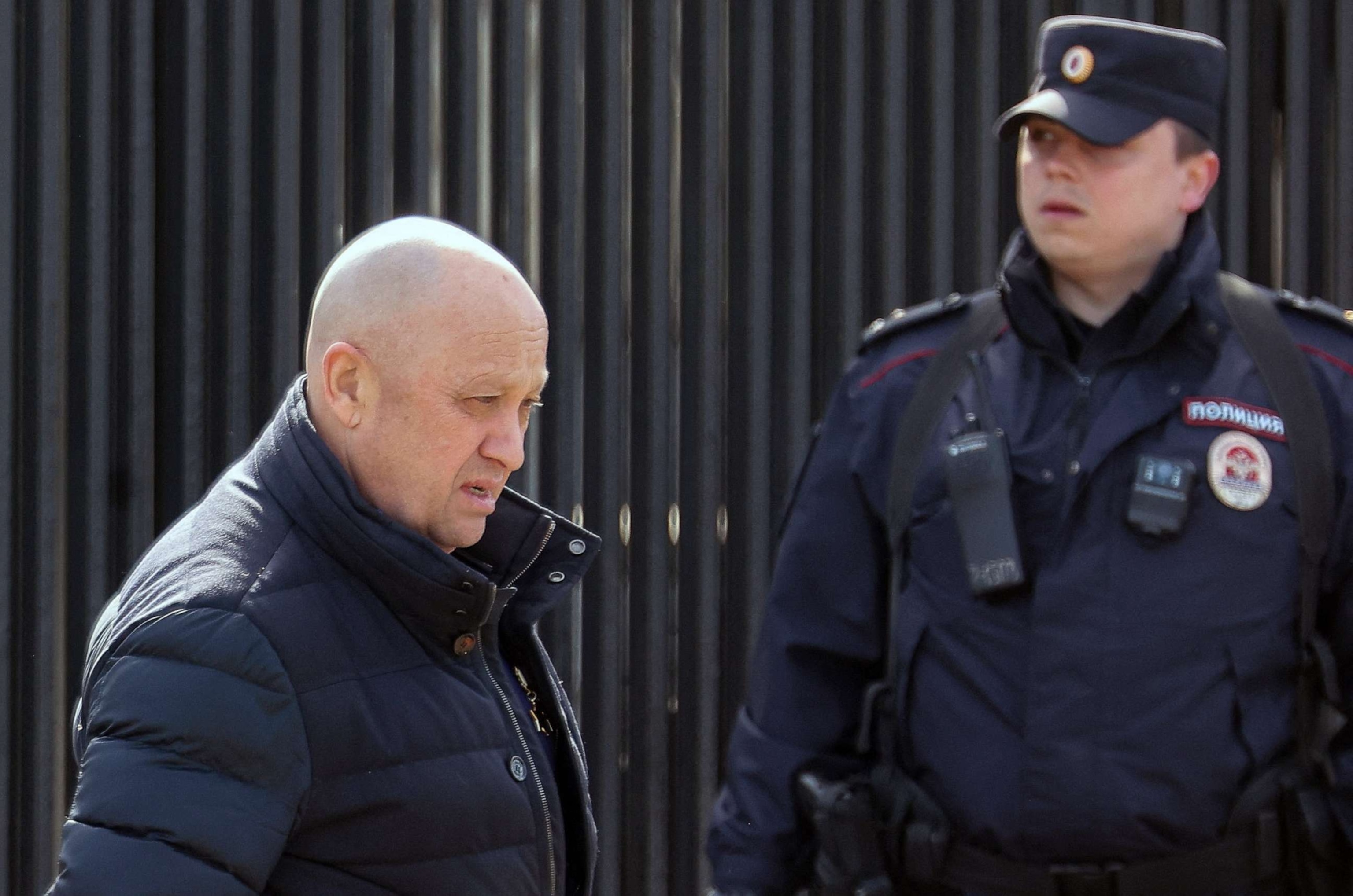 PHOTO: Founder of Wagner private mercenary group Yevgeny Prigozhin walks past a police officer in Moscow, April 8, 2023.