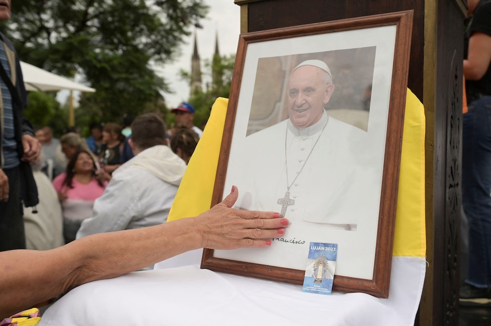 PHOTO: A person touches a portrait of Pope Francis during a Mass to pray for Pope Francis' health at the Plaza Constitucion in Buenos Aires, Argentina, Feb. 24, 2025.