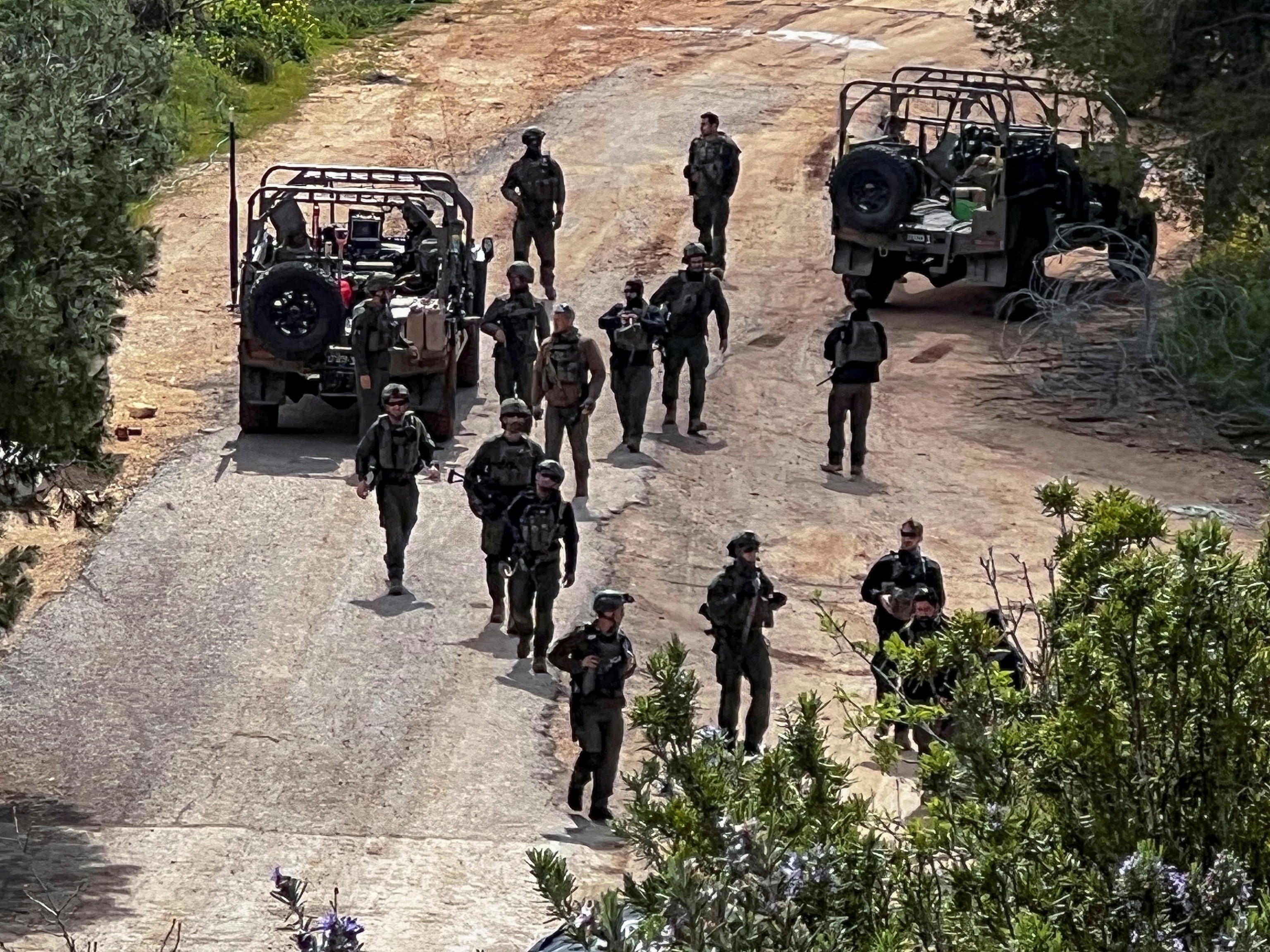 PHOTO: Israeli soldiers walk next to military vehicles on the Israeli side of the Israel-Lebanon border, amid escalation between Hezbollah and Israel, and amid the U.S.-Israeli conflict with Iran, in northern Israel, March 16, 2026. 
