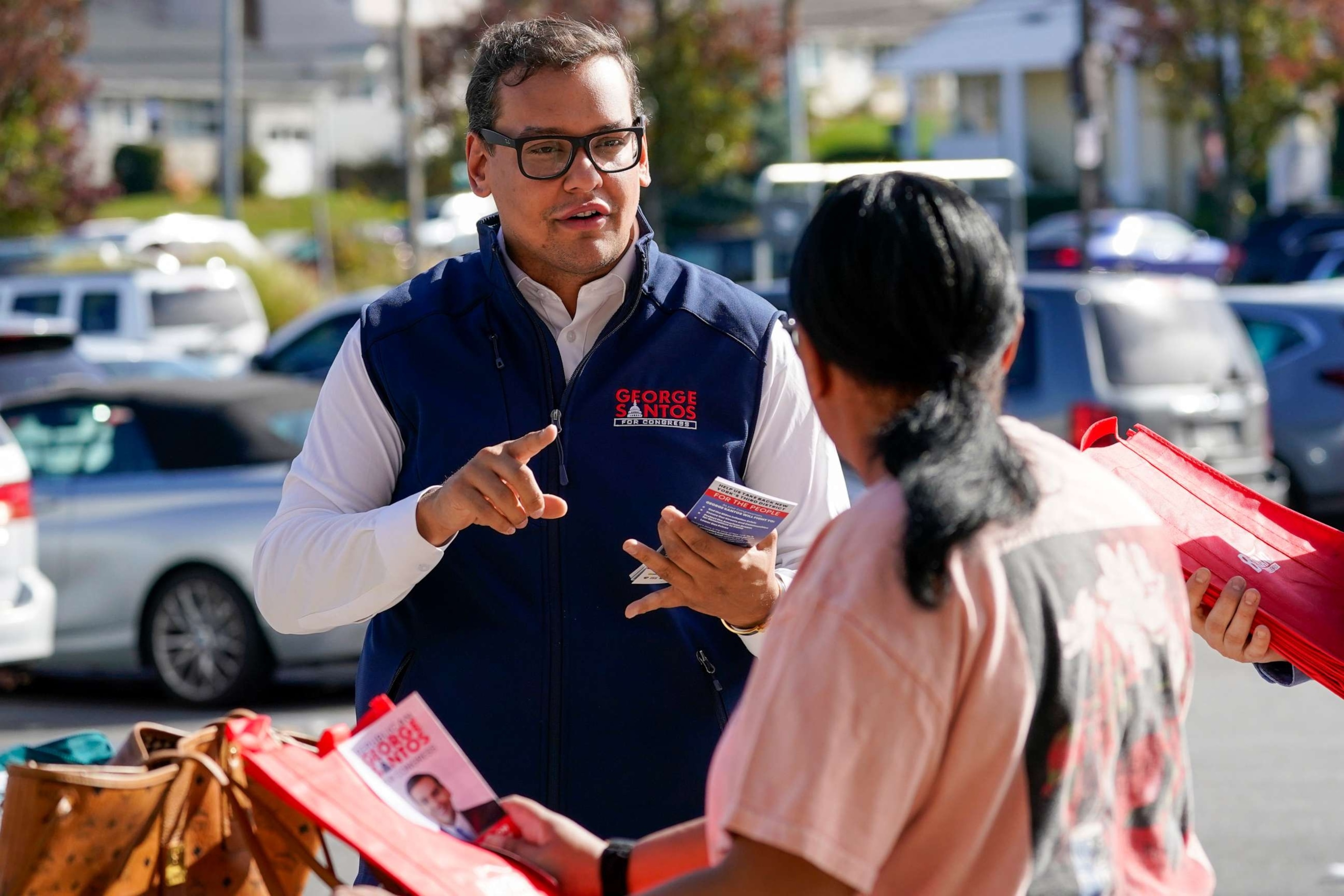 PHOTO: Republican Candidate for New York's 3rd Congressional District George Santos, left, talks to a voter while campaigning outside a Stop and Shop store, Saturday, Nov. 5, 2022, in Glen Cove, N.Y.